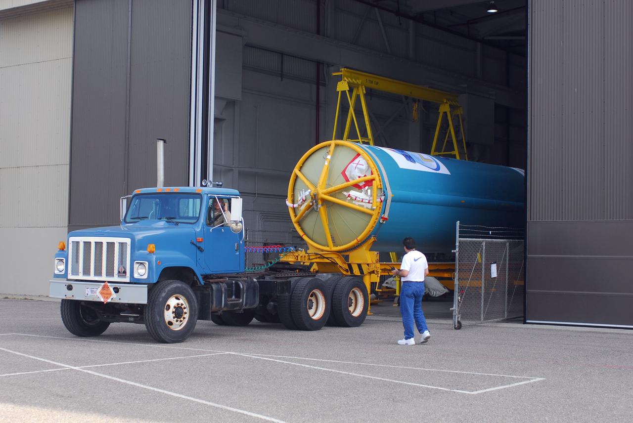 VANDENBERG AIR FORCE BASE, Calif. -- At Vandenberg Air Force Base in California, the first stage of a United Launch Alliance Delta II that will carry the National Polar-orbiting Operational Environmental Satellite System Preparatory Project (NPP) satellite into space is on its way from NASA Hangar 836 to NASA's Launch Complex-2. The vehicle then will undergo initial testing at the United Launch Alliance Delta Mission Checkout Facility.      NPP will be positioned 512 miles above the Earth's surface and will orbit about 16 times each day to observe nearly the entire globe. The NPP mission for NASA and the National Oceanic and Atmospheric Administration (NOAA) is to measure Earth's atmospheric and sea surface temperatures, humidity sounding, land and ocean biological activity, and cloud and aerosol properties. For more information, visit www.nasa.gov/NPP. Photo credit: NASA/VAFB