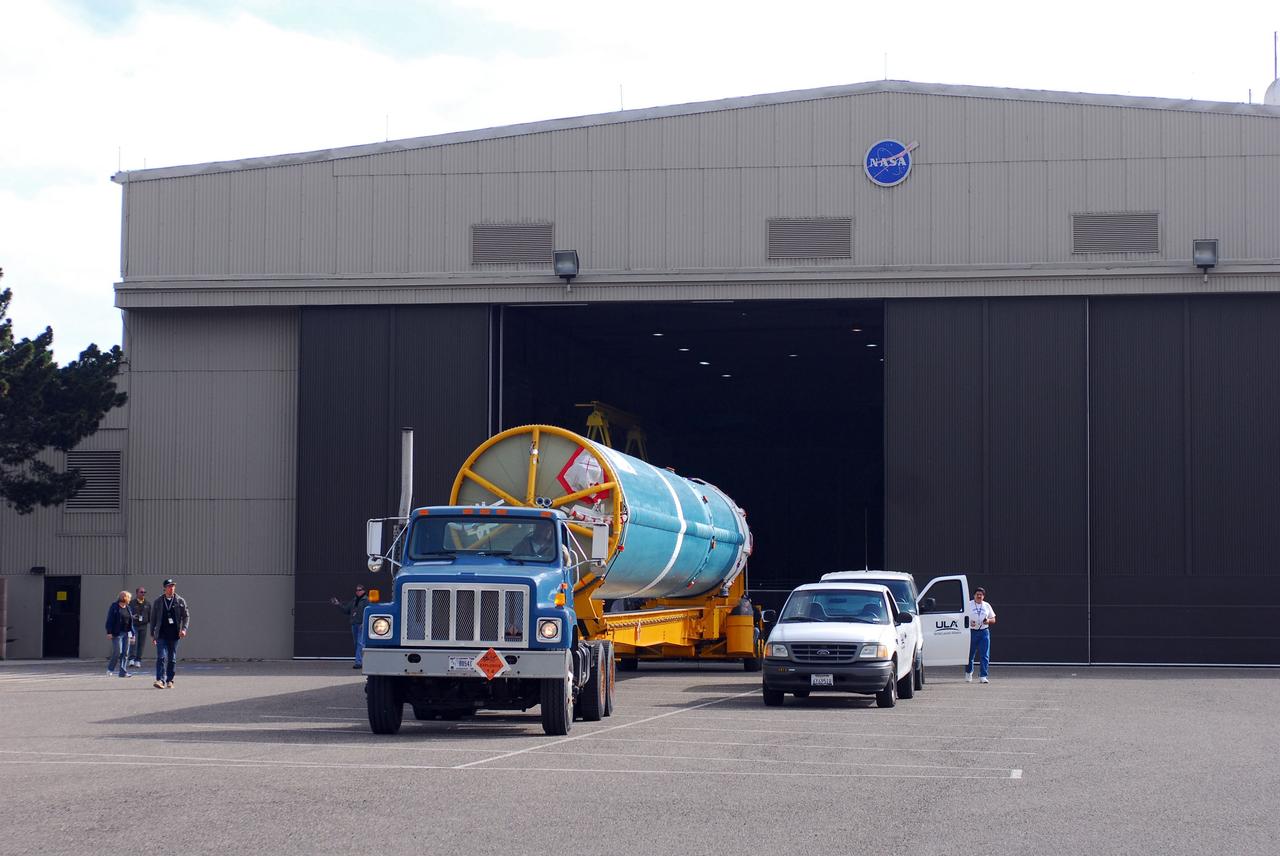 VANDENBERG AIR FORCE BASE, Calif. -- At Vandenberg Air Force Base in California, the first stage of a United Launch Alliance Delta II that will carry the National Polar-orbiting Operational Environmental Satellite System Preparatory Project (NPP) satellite into space is on its way from NASA Hangar 836 to NASA's Launch Complex-2. The vehicle then will undergo initial testing at the United Launch Alliance Delta Mission Checkout Facility.       NPP will be positioned 512 miles above the Earth's surface and will orbit about 16 times each day to observe nearly the entire globe. The NPP mission for NASA and the National Oceanic and Atmospheric Administration (NOAA) is to measure Earth's atmospheric and sea surface temperatures, humidity sounding, land and ocean biological activity, and cloud and aerosol properties. For more information, visit www.nasa.gov/NPP. Photo credit: NASA/VAFB