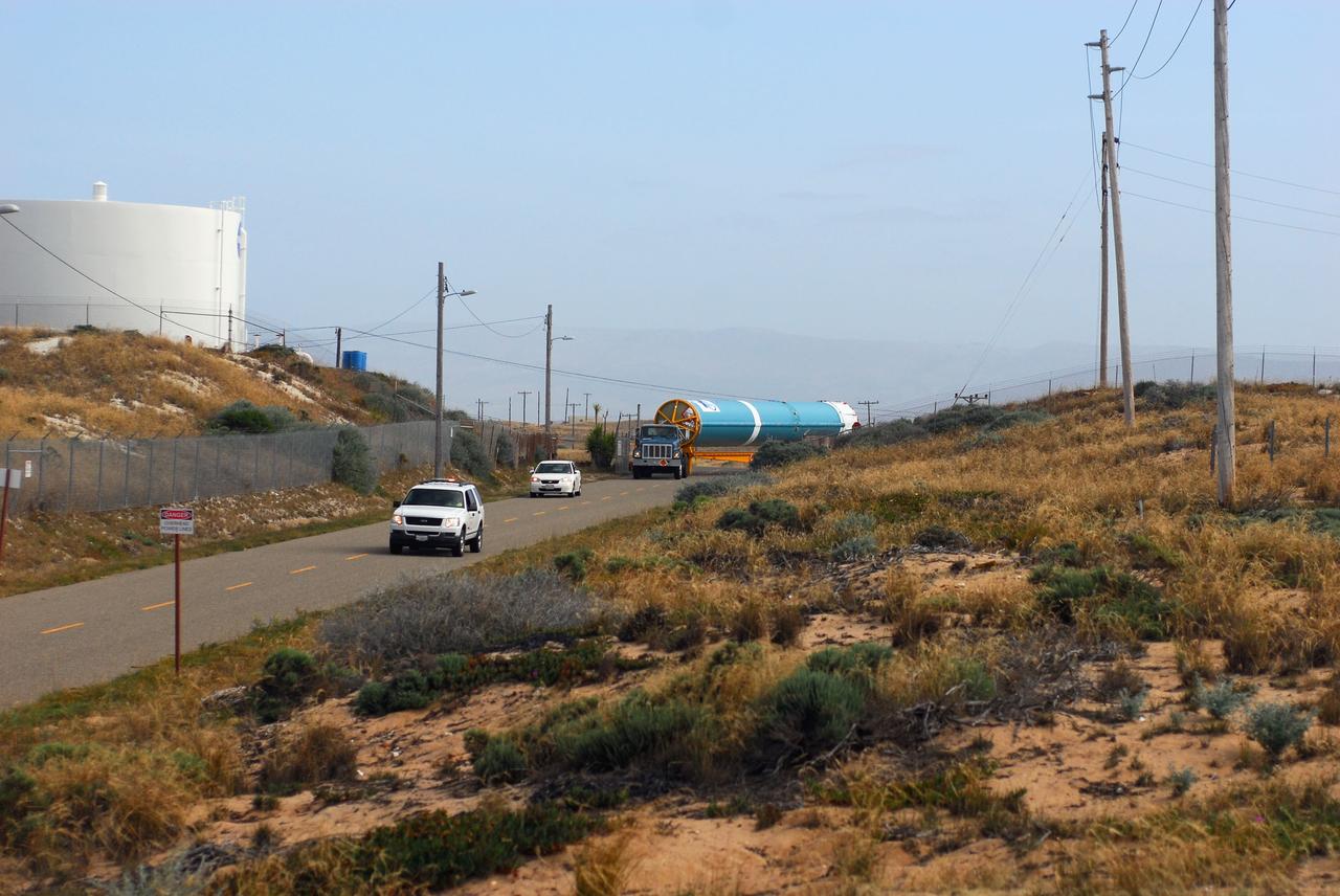 VANDENBERG AIR FORCE BASE, Calif. -- At Vandenberg Air Force Base in California, the first stage of a United Launch Alliance Delta II that will carry the National Polar-orbiting Operational Environmental Satellite System Preparatory Project (NPP) satellite into space is on its way from NASA Hangar 836 to NASA's Launch Complex-2. The vehicle then will undergo initial testing at the United Launch Alliance Delta Mission Checkout Facility.       NPP will be positioned 512 miles above the Earth's surface and will orbit about 16 times each day to observe nearly the entire globe. The NPP mission for NASA and the National Oceanic and Atmospheric Administration (NOAA) is to measure Earth's atmospheric and sea surface temperatures, humidity sounding, land and ocean biological activity, and cloud and aerosol properties. For more information, visit www.nasa.gov/NPP. Photo credit: NASA/VAFB