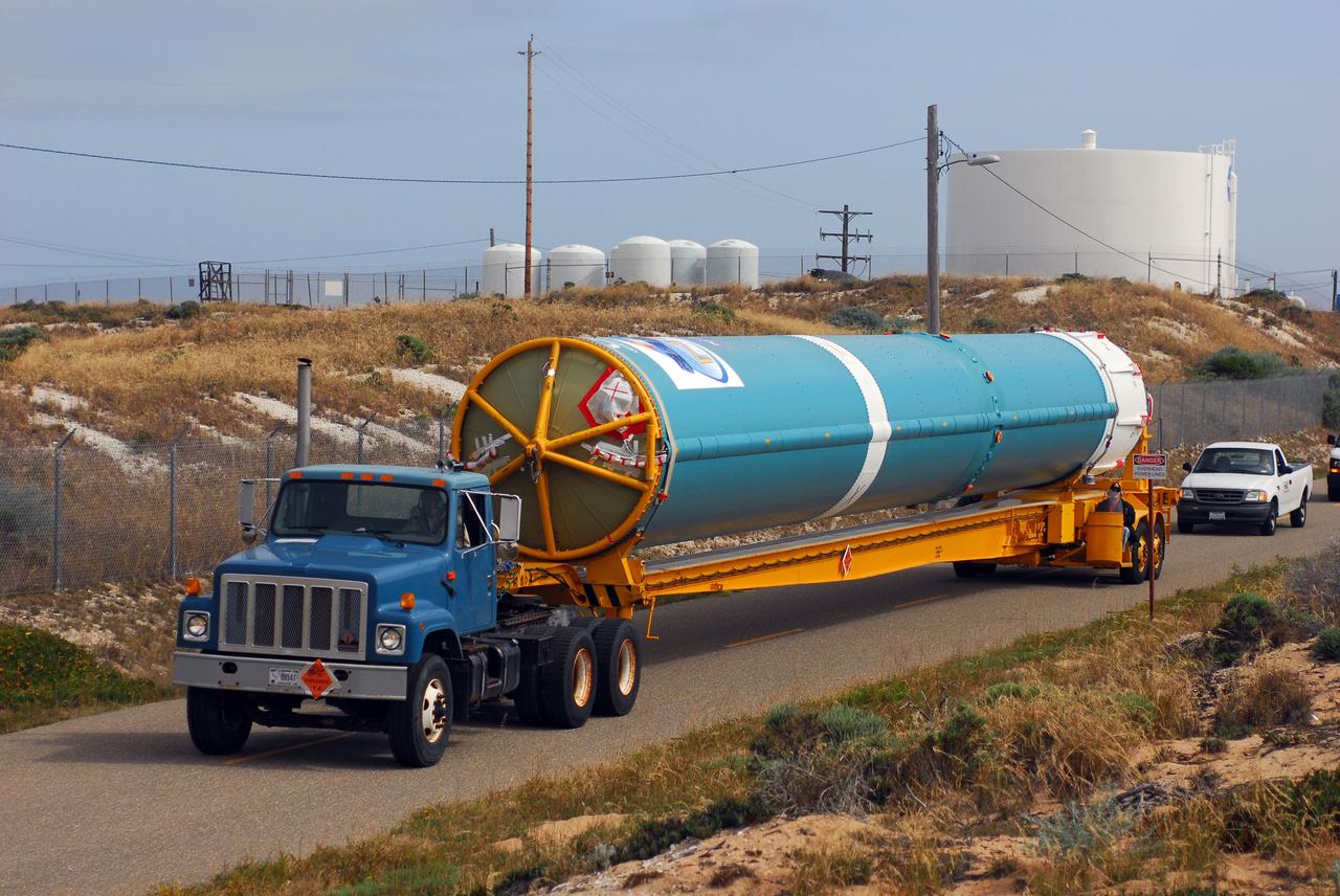 VANDENBERG AIR FORCE BASE, Calif. -- At Vandenberg Air Force Base in California, the first stage of a United Launch Alliance Delta II that will carry the National Polar-orbiting Operational Environmental Satellite System Preparatory Project (NPP) satellite into space is on its way from NASA Hangar 836 to NASA's Launch Complex-2. The vehicle then will undergo initial testing at the United Launch Alliance Delta Mission Checkout Facility.       NPP will be positioned 512 miles above the Earth's surface and will orbit about 16 times each day to observe nearly the entire globe. The NPP mission for NASA and the National Oceanic and Atmospheric Administration (NOAA) is to measure Earth's atmospheric and sea surface temperatures, humidity sounding, land and ocean biological activity, and cloud and aerosol properties. For more information, visit www.nasa.gov/NPP. Photo credit: NASA/VAFB