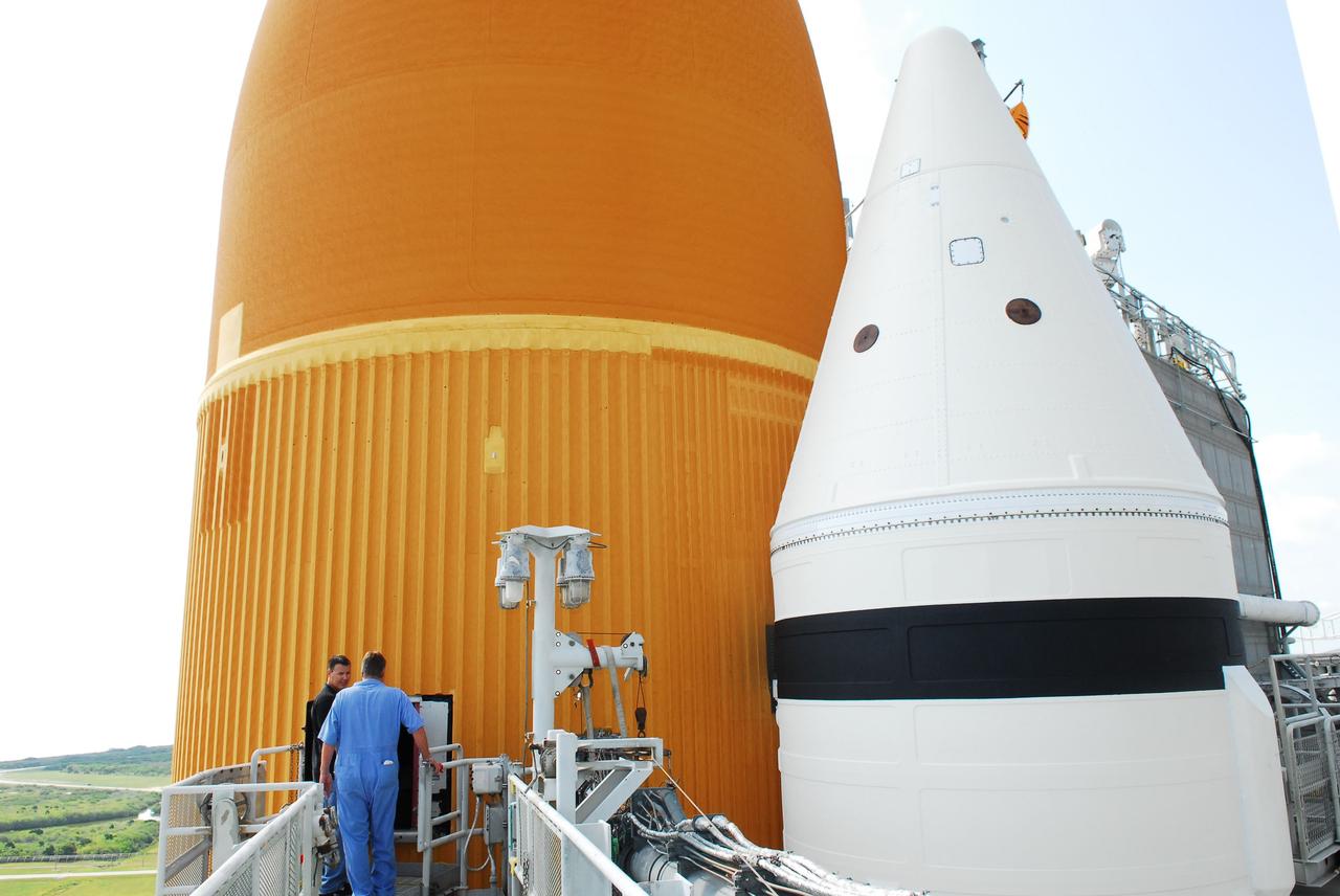 CAPE CANAVERAL, Fla. -- At NASA's Kennedy Space Center in Florida, technicians prepare to conduct Computed Radiography (CR) X-ray scans of 50 support beams, called stringers, on the shuttle-facing side of Atlantis' external tank at Launch Pad 39A. The hi-tech images will be taken of the tops and bottoms of the 21-foot long beams, which are located on the tank's intertank section. The scans follow a June 15th tanking test when the launch team filled then drained the tank of about 535,000 gallons of liquid hydrogen and liquid oxygen, just like for a launch. Earlier this year, managers directed teams to make the same stringer modifications to Atlantis' tank, ET-138, as they had after small cracks in the support beams of shuttle Discovery's STS-133 mission external tank were discovered. The scans will confirm there are no issues with Atlantis' tank.              STS-135 Commander Chris Ferguson, Pilot Doug Hurley and Mission Specialists Sandy Magnus and Rex Walheim are targeted to lift off on space shuttle Atlantis July 8, taking with them the MPLM packed with supplies, logistics and spare parts to the International Space Station. The STS-135 mission also will fly a system to investigate the potential for robotically refueling existing satellites and return a failed ammonia pump module to help NASA better understand the failure mechanism and improve pump designs for future systems. STS-135 will be the 33rd flight of Atlantis, the 37th shuttle mission to the space station, and the 135th and final mission of NASA's Space Shuttle Program. For more information visit, www.nasa.gov/mission_pages/shuttle/shuttlemissions/sts135/index.html. Photo credit: NASA/Jim Grossmann
