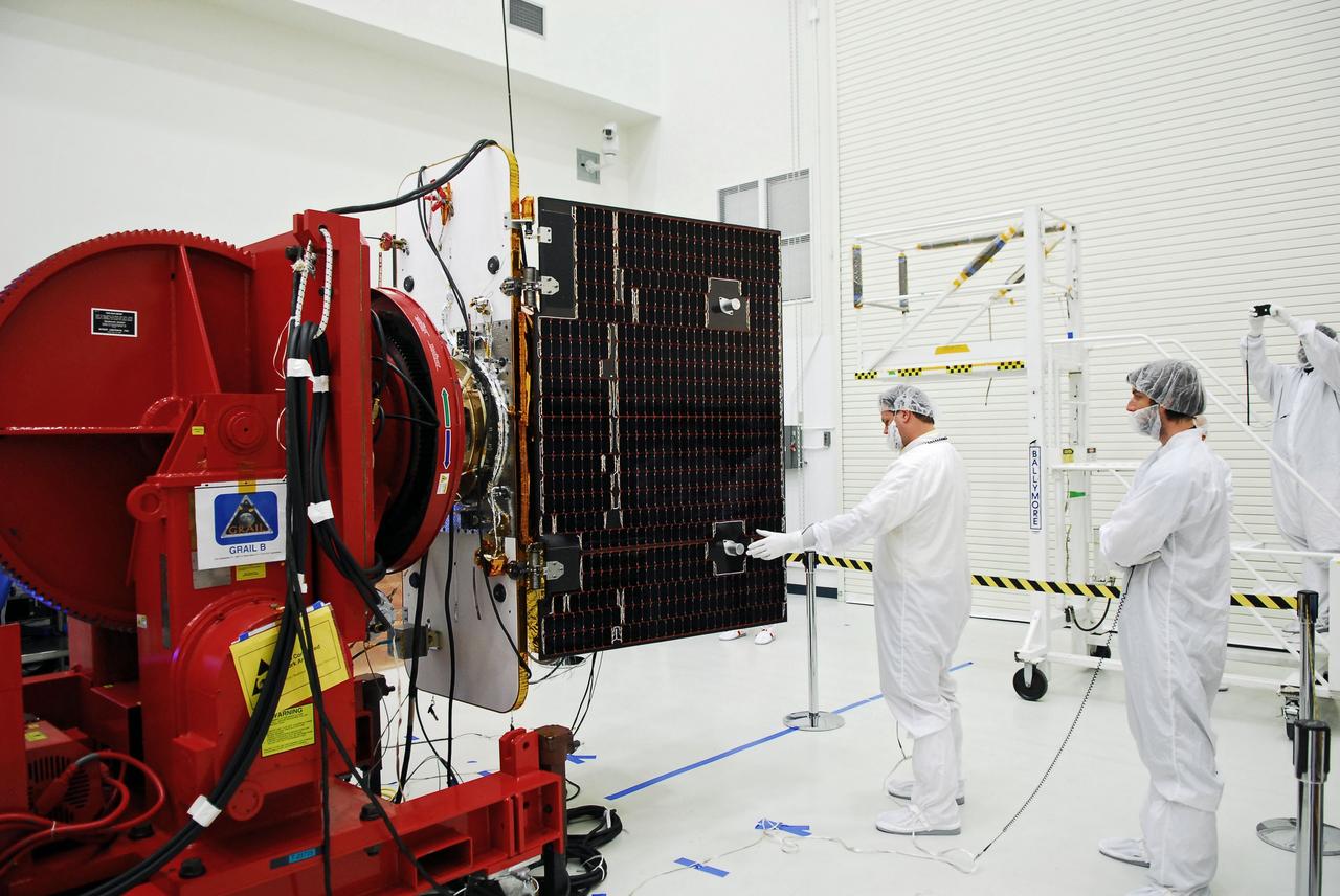 CAPE CANAVERAL, Fla. -- Technicians at Astrotech payload processing facility in Titusville, Fla., are conducting solar panel deployment tests on NASA's Gravity Recovery and Interior Laboratory, or GRAIL, twin spacecraft. The United Launch Alliance Delta II rocket that will carry GRAIL into lunar orbit already is fully stacked at NASA's Space Launch Complex 17B, and launch is scheduled for Sept. 8. The GRAIL mission is a part of NASA's Discovery Program. GRAIL will fly the twin spacecraft in tandem orbits around the moon for several months to measure its gravity field. The mission also will answer longstanding questions about Earth's moon and provide scientists a better understanding of how Earth and other rocky planets in the solar system formed. For more information, visit http://solarsystem.nasa.gov/grail/. Photo credit: NASA/Jim Grossmann