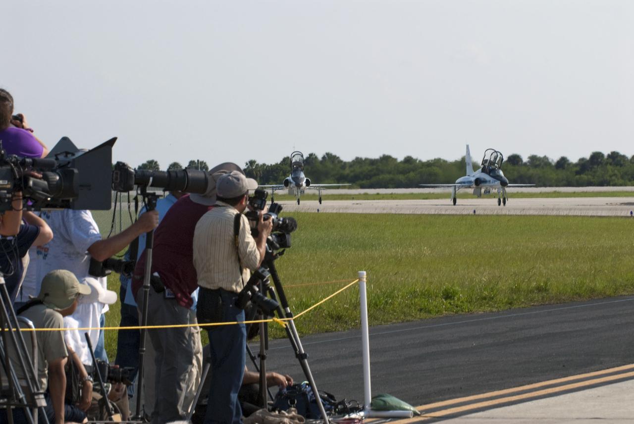 CAPE CANAVERAL, Fla. -- At the Shuttle Landing Facility at NASA's Kennedy Space Center in Florida, space shuttle Atlantis' crew members begin to arrive aboard their T-38 jets while media snap photos of their arrival. The astronauts are at Kennedy to participate in a launch countdown dress rehearsal called the Terminal Countdown Demonstration Test (TCDT) and related training in preparation for the upcoming STS-135 mission. Atlantis is targeted to lift off on July 8, taking with them the Raffaello multi-purpose logistics module packed with supplies, and spare parts to the International Space Station. The STS-135 mission also will fly a system to investigate the potential for robotically refueling existing satellites and return a failed ammonia pump module to help NASA better understand the failure mechanism and improve pump designs for future systems. STS-135 will be the 33rd flight of Atlantis, the 37th shuttle mission to the space station, and the 135th and final mission of NASA's Space Shuttle Program. For more information visit, www.nasa.gov/mission_pages/shuttle/shuttlemissions/sts135/index.html. Photo credit: NASA/Kim Shiflett
