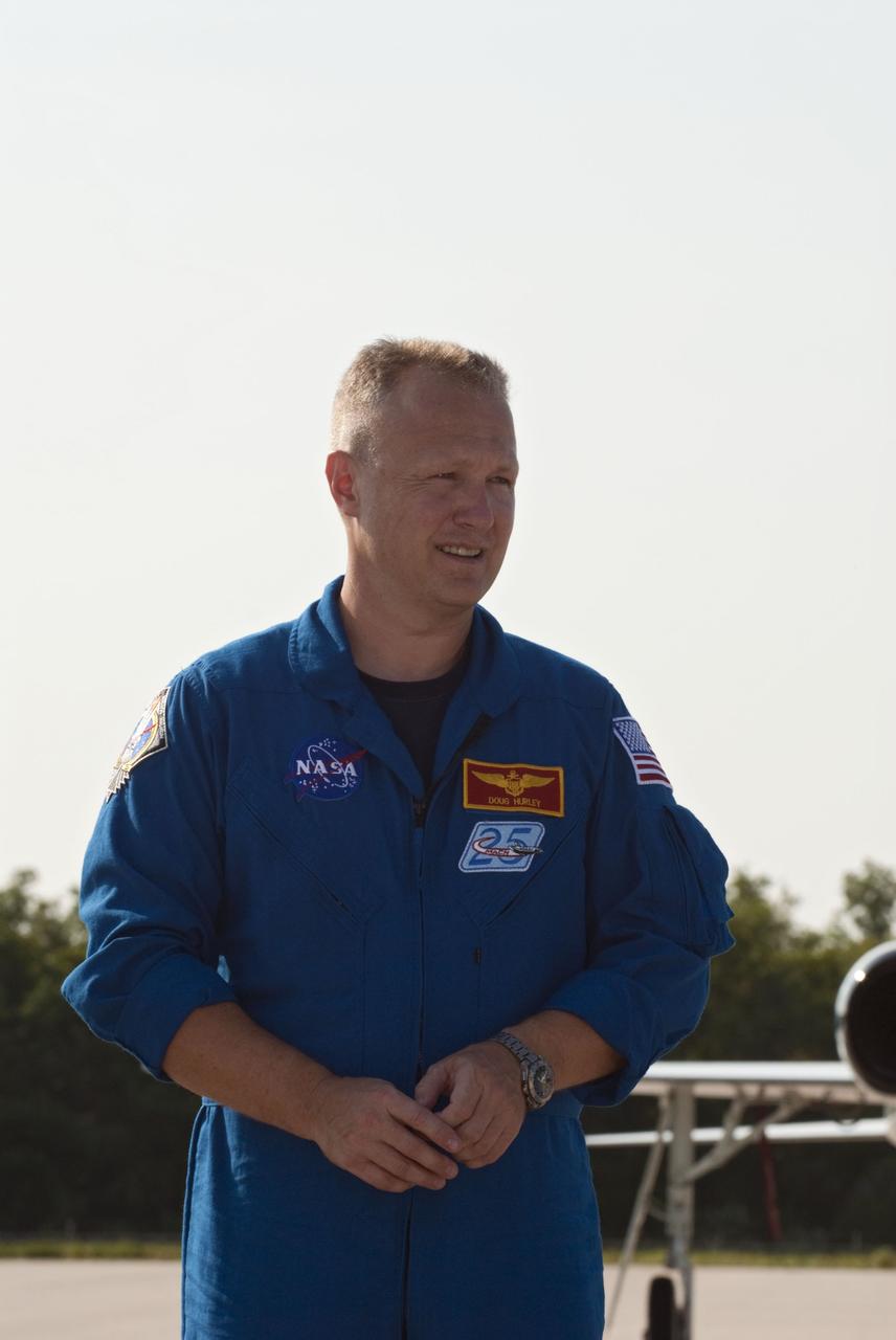 CAPE CANAVERAL, Fla. -- At the Shuttle Landing Facility at NASA's Kennedy Space Center in Florida, STS-135 Pilot Doug Hurley pauses for a photo. The space shuttle Atlantis crew arrived at Kennedy at about 5:30 p.m. EDT to participate in a launch countdown dress rehearsal called the Terminal Countdown Demonstration Test (TCDT) and related training in preparation for the upcoming STS-135 mission.    Atlantis and its crew is targeted to lift off on July 8, taking with them the Raffaello multi-purpose logistics module packed with supplies and spare parts to the International Space Station. The STS-135 mission also will fly a system to investigate the potential for robotically refueling existing satellites and return a failed ammonia pump module to help NASA better understand the failure mechanism and improve pump designs for future systems. STS-135 will be the 33rd flight of Atlantis, the 37th shuttle mission to the space station, and the 135th and final mission of NASA's Space Shuttle Program. For more information visit, www.nasa.gov/mission_pages/shuttle/shuttlemissions/sts135/index.html. Photo credit: NASA/Kim Shiflett