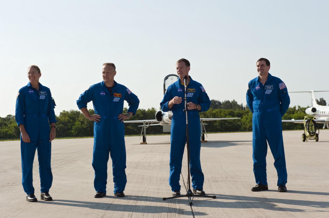 CAPE CANAVERAL, Fla. -- Space shuttle Atlantis' STS-135 crew members address the media on the Shuttle Landing Facility at NASA's Kennedy Space Center in Florida. From left are Mission Specialist Sandy Magnus, Pilot Doug Hurley, Commander Chris Ferguson and Mission Specialist Rex Walheim. The crew arrived at Kennedy at about 5:30 p.m. EDT to participate in a launch countdown dress rehearsal called the Terminal Countdown Demonstration Test (TCDT) and related training in preparation for the upcoming STS-135 mission.       Atlantis and its crew are targeted to lift off July 8, taking with them the Raffaello multi-purpose logistics module packed with supplies and spare parts to the International Space Station. The STS-135 mission also will fly a system to investigate the potential for robotically refueling existing satellites and return a failed ammonia pump module to help NASA better understand the failure mechanism and improve pump designs for future systems. STS-135 will be the 33rd flight of Atlantis, the 37th shuttle mission to the International Space Station, and the 135th and final mission of NASA's Space Shuttle Program. For more information visit, www.nasa.gov/mission_pages/shuttle/shuttlemissions/sts135/index.html. Photo credit: NASA/Kim Shiflett