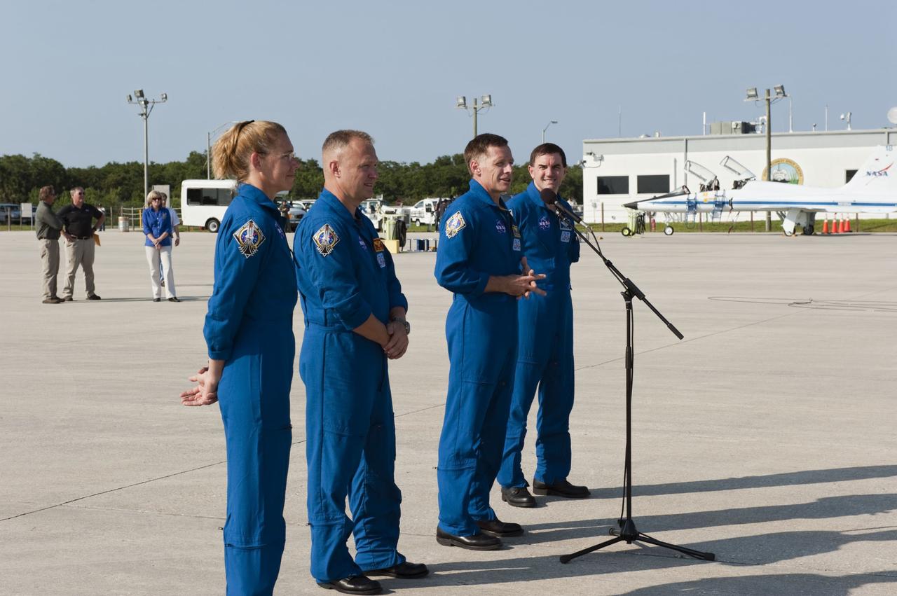 CAPE CANAVERAL, Fla. -- Space shuttle Atlantis' STS-135 crew address the media on the Shuttle Landing Facility at NASA's Kennedy Space Center in Florida. From left are Mission Specialist Sandy Magnus, Pilot Doug Hurley, Commander Chris Ferguson and Mission Specialist Rex Walheim. While at Kennedy, Atlantis' crew will participate in a launch countdown dress rehearsal called the Terminal Countdown Demonstration Test (TCDT) and related training in preparation for the upcoming STS-135 mission.       The STS-135 crew members are targeted to lift off on July 8, taking with them the Raffaello multi-purpose logistics module packed with supplies, logistics and spare parts to the International Space Station. The STS-135 mission also will fly a system to investigate the potential for robotically refueling existing satellites and return a failed ammonia pump module to help NASA better understand the failure mechanism and improve pump designs for future systems. STS-135 will be the 33rd flight of Atlantis, the 37th shuttle mission to the space station, and the 135th and final mission of NASA's Space Shuttle Program. For more information visit, www.nasa.gov/mission_pages/shuttle/shuttlemissions/sts135/index.html. Photo credit: NASA/Kim Shiflett