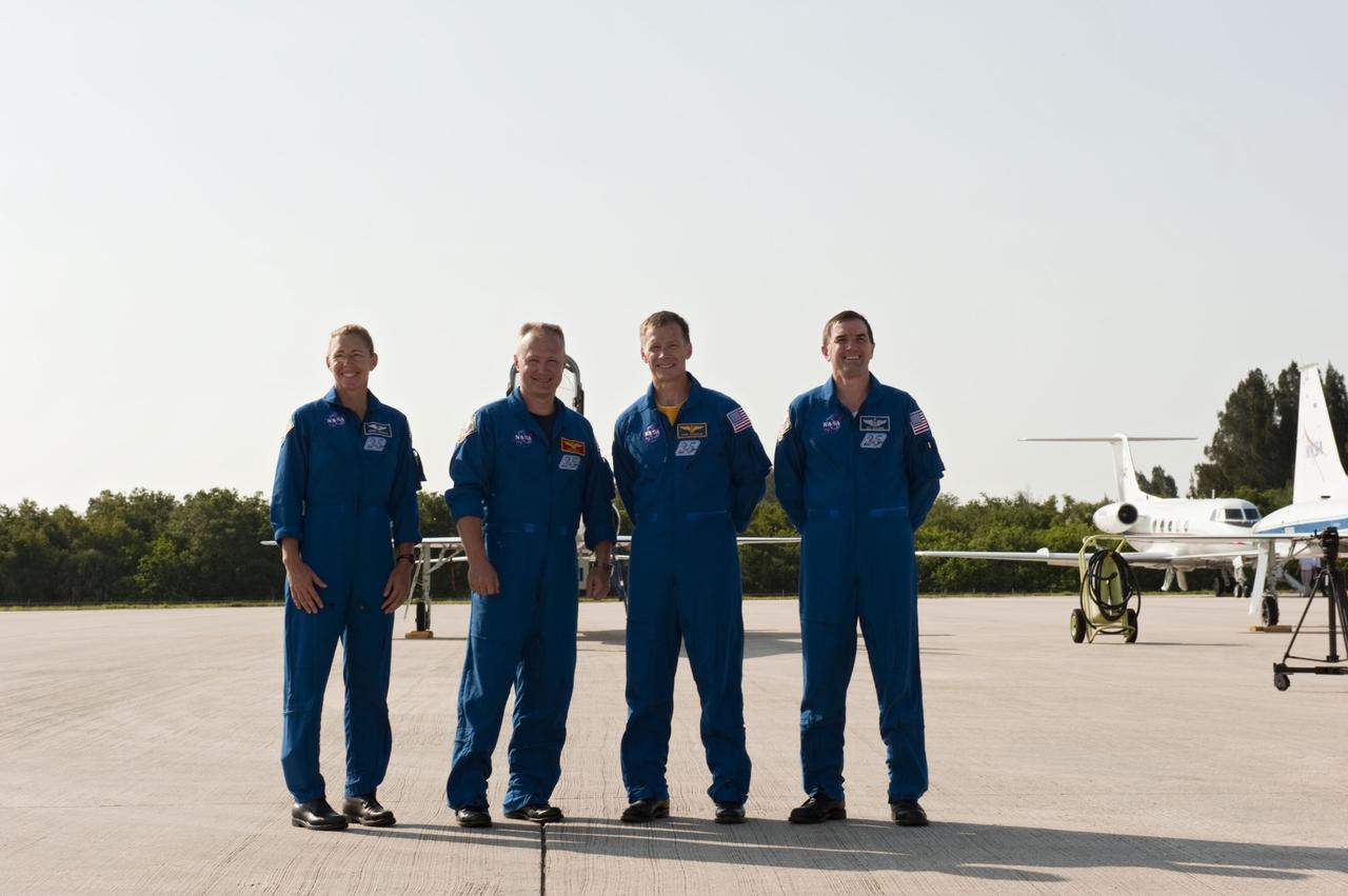 CAPE CANAVERAL, Fla. -- Space shuttle Atlantis' STS-135 crew members pose for a group photo on the Shuttle Landing Facility at NASA's Kennedy Space Center in Florida. From left are Mission Specialist Sandy Magnus, Pilot Doug Hurley, Commander Chris Ferguson and Mission Specialist Rex Walheim. The crew arrived at Kennedy at about 5:30 p.m. EDT to participate in a launch countdown dress rehearsal called the Terminal Countdown Demonstration Test (TCDT) and related training in preparation for the upcoming STS-135 mission.     Targeted to lift off July 8, the Atlantis crew will deliver the Raffaello multi-purpose logistics module packed with supplies and spare parts to the International Space Station. Atlantis also will fly a system to investigate the potential for robotically refueling existing satellites and return a failed ammonia pump module to help NASA better understand the failure mechanism and improve pump designs for future systems. STS-135 will be the 33rd flight of Atlantis, the 37th shuttle mission to the station, and the 135th and final mission of NASA's Space Shuttle Program. For more information visit, www.nasa.gov/mission_pages/shuttle/shuttlemissions/sts135/index.html. Photo credit: NASA/Kim Shiflett