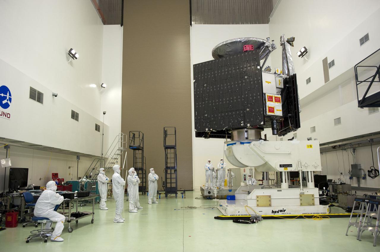 CAPE CANAVERAL, Fla. -- Technicians at Astrotech's payload processing facility in Titusville, Fla. watch vigilantly as NASA's Juno spacecraft is tested for center of gravity, weighing and balancing on the rotation stand.        Juno is scheduled to launch aboard United Launch Alliance Atlas V rocket from Cape Canaveral, Fla. Aug. 5.The solar-powered spacecraft will orbit Jupiter's poles 33 times to find out more about the gas giant's origins, structure, atmosphere and magnetosphere and investigate the existence of a solid planetary core. For more information visit: www.nasa.gov/juno. Photo credit: NASA/Kim Shiflett