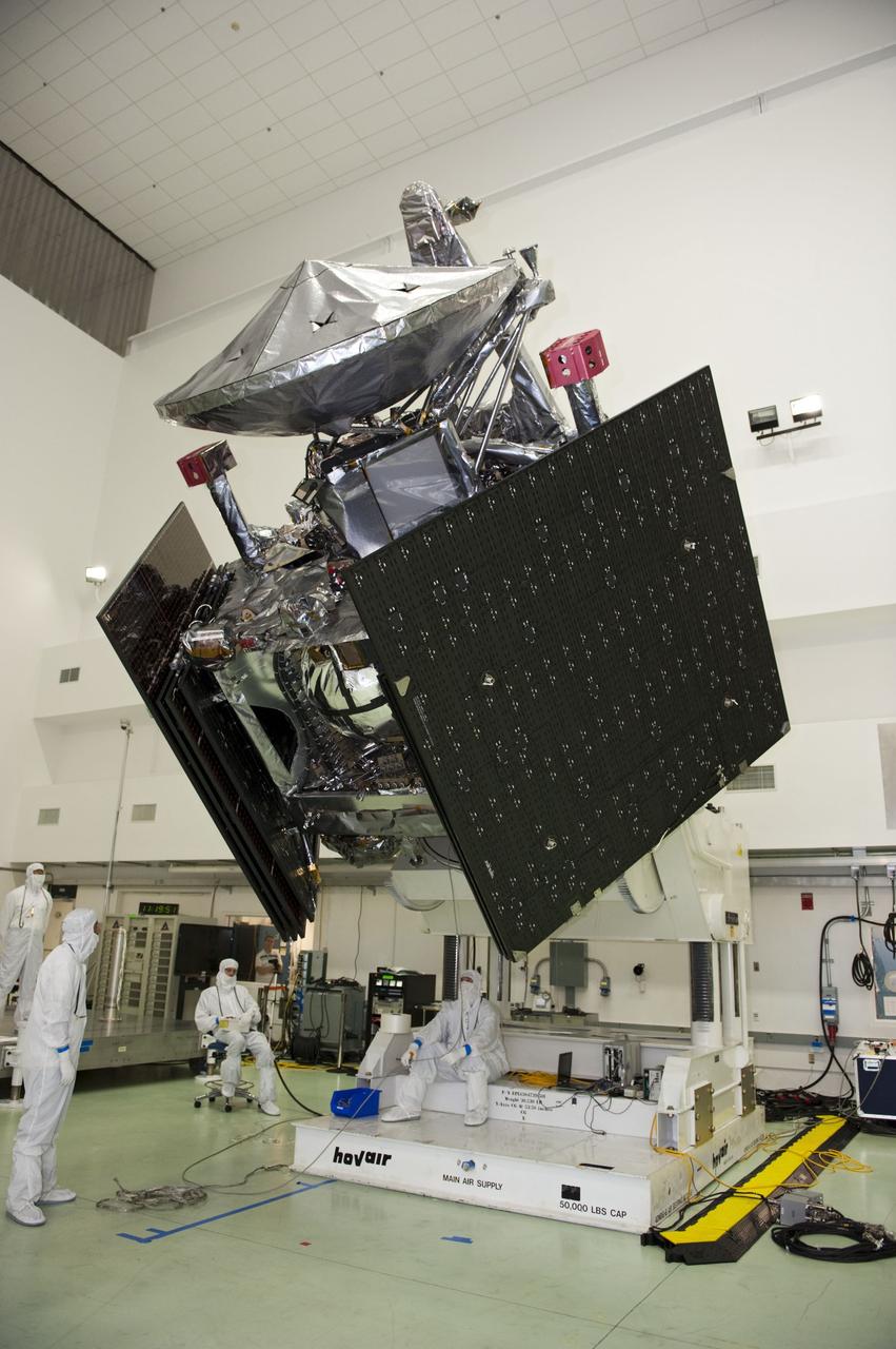 CAPE CANAVERAL, Fla. -- Technicians at Astrotech's payload processing facility in Titusville, Fla. watch vigilantly as NASA's Juno spacecraft is tested for center of gravity, weighing and balancing on the rotation stand.        Juno is scheduled to launch aboard United Launch Alliance Atlas V rocket from Cape Canaveral, Fla. Aug. 5.The solar-powered spacecraft will orbit Jupiter's poles 33 times to find out more about the gas giant's origins, structure, atmosphere and magnetosphere and investigate the existence of a solid planetary core. For more information visit: www.nasa.gov/juno. Photo credit: NASA/Kim Shiflett