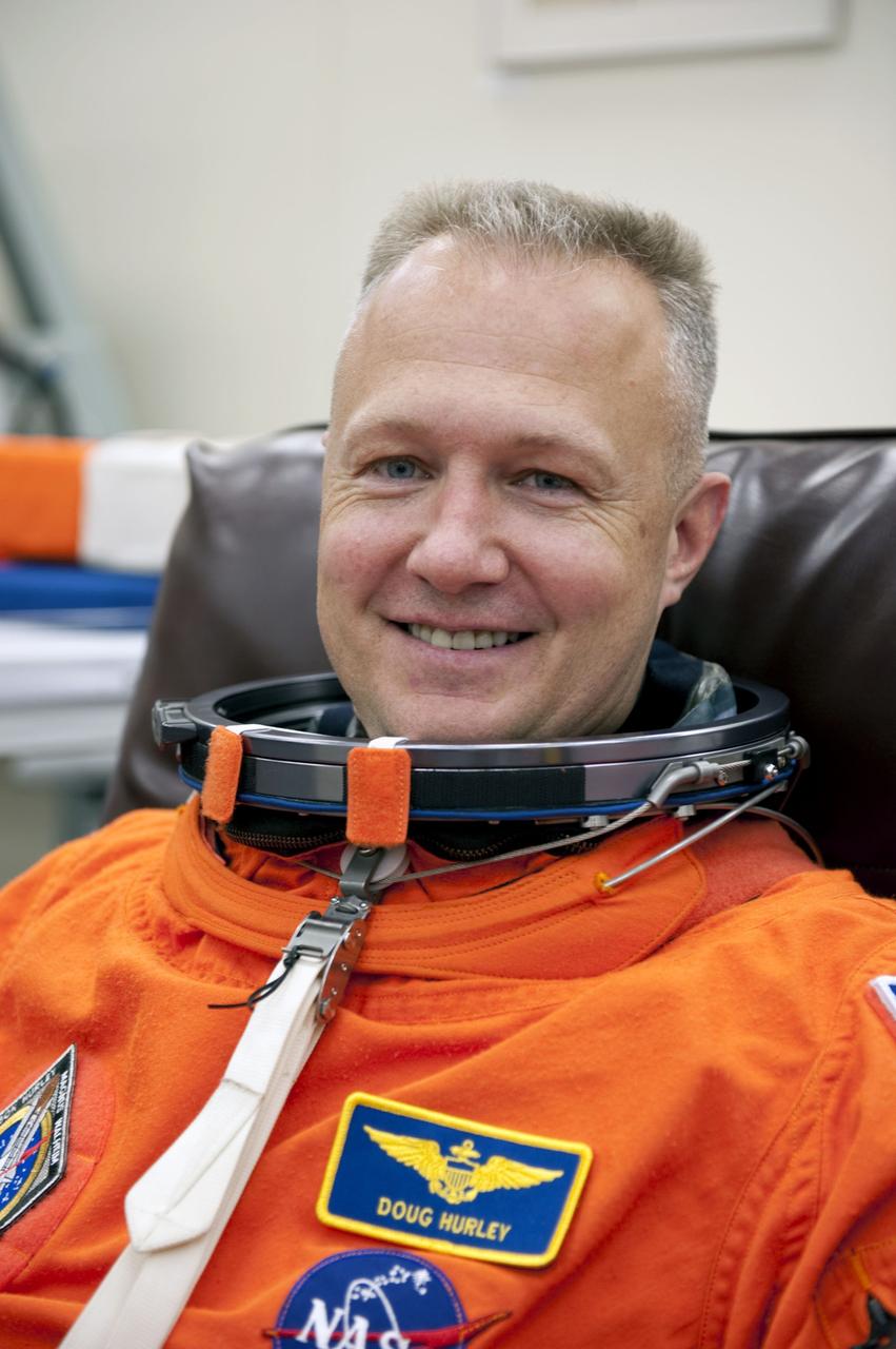 CAPE CANAVERAL, Fla. -- In the Operations and Checkout Building at NASA's Kennedy Space Center in Florida, Pilot Doug Hurley checks the fit of his launch and landing suit. The STS-135 crew is at Kennedy to participate in a launch countdown dress rehearsal called the Terminal Countdown Demonstration Test (TCDT) and related training in preparation for the upcoming STS-135 mission.              Atlantis and its crew are targeted to lift off July 8, taking with them the Raffaello multi-purpose logistics module packed with supplies and spare parts to the International Space Station. The STS-135 mission also will fly a system to investigate the potential for robotically refueling existing satellites and return a failed ammonia pump module to help NASA better understand the failure mechanism and improve pump designs for future systems. STS-135 will be the 33rd flight of Atlantis, the 37th shuttle mission to the space station, and the 135th and final mission of NASA's Space Shuttle Program. For more information visit, www.nasa.gov/mission_pages/shuttle/shuttlemissions/sts135/index.html.  Photo credit: NASA/Kim Shiflett