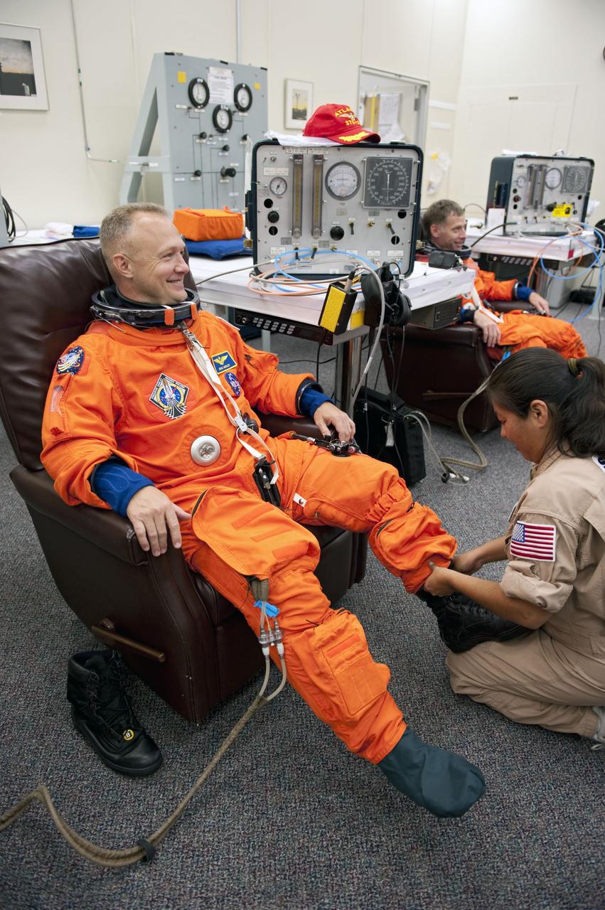 CAPE CANAVERAL, Fla. -- In the Operations and Checkout Building at NASA's Kennedy Space Center in Florida, Pilot Doug Hurley has his launch and landing suit checked by suit technician Cathy Cruz. The STS-135 crew is at Kennedy to participate in a launch countdown dress rehearsal called the Terminal Countdown Demonstration Test (TCDT) and related training in preparation for the upcoming STS-135 mission.          Atlantis and its crew are targeted to lift off July 8, taking with them the Raffaello multi-purpose logistics module packed with supplies and spare parts to the International Space Station. The STS-135 mission also will fly a system to investigate the potential for robotically refueling existing satellites and return a failed ammonia pump module to help NASA better understand the failure mechanism and improve pump designs for future systems. STS-135 will be the 33rd flight of Atlantis, the 37th shuttle mission to the space station, and the 135th and final mission of NASA's Space Shuttle Program. For more information visit, www.nasa.gov/mission_pages/shuttle/shuttlemissions/sts135/index.html.  Photo credit: NASA/Kim Shiflett