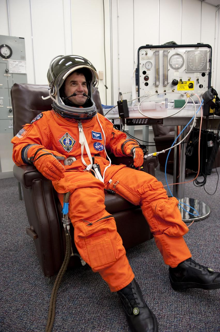 CAPE CANAVERAL, Fla. -- In the Operations and Checkout Building at NASA's Kennedy Space Center in Florida, Mission Specialist Rex Walheim checks the fit of his launch and landing suit, helmet and gloves. The STS-135 crew is at Kennedy to participate in a launch countdown dress rehearsal called the Terminal Countdown Demonstration Test (TCDT) and related training in preparation for the upcoming STS-135 mission. Atlantis and its crew are targeted to lift off July 8, taking with them the Raffaello multi-purpose logistics module packed with supplies and spare parts to the International Space Station. The STS-135 mission also will fly a system to investigate the potential for robotically refueling existing satellites and return a failed ammonia pump module to help NASA better understand the failure mechanism and improve pump designs for future systems. STS-135 will be the 33rd flight of Atlantis, the 37th shuttle mission to the space station, and the 135th and final mission of NASA's Space Shuttle Program. For more information visit, www.nasa.gov/mission_pages/shuttle/shuttlemissions/sts135/index.html. Photo credit: NASA/Kim Shiflett