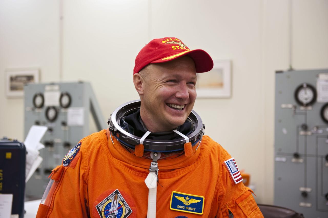 CAPE CANAVERAL, Fla. -- In the Operations and Checkout Building at NASA's Kennedy Space Center in Florida, Pilot Doug Hurley pauses for a photo after donning his launch and landing suit. The STS-135 crew is at Kennedy to participate in a launch countdown dress rehearsal called the Terminal Countdown Demonstration Test (TCDT) and related training in preparation for the upcoming STS-135 mission.        Atlantis and its crew are targeted to lift off July 8, taking with them the Raffaello multi-purpose logistics module packed with supplies and spare parts to the International Space Station. The STS-135 mission also will fly a system to investigate the potential for robotically refueling existing satellites and return a failed ammonia pump module to help NASA better understand the failure mechanism and improve pump designs for future systems. STS-135 will be the 33rd flight of Atlantis, the 37th shuttle mission to the space station, and the 135th and final mission of NASA's Space Shuttle Program. For more information visit, www.nasa.gov/mission_pages/shuttle/shuttlemissions/sts135/index.html.  Photo credit: NASA/Kim Shiflett