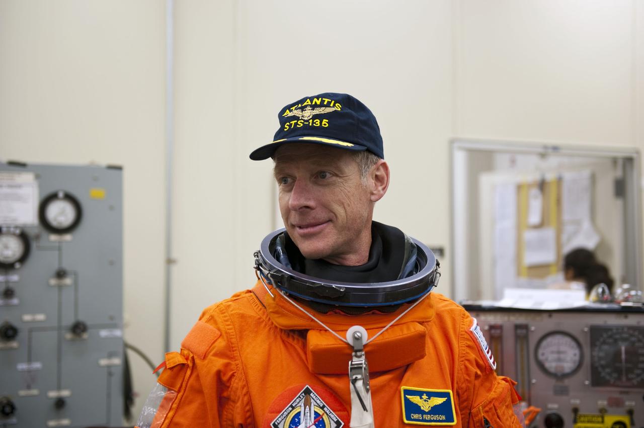 CAPE CANAVERAL, Fla. -- In the Operations and Checkout Building at NASA's Kennedy Space Center in Florida, Commander Chris Ferguson pauses for a photo after donning his launch and landing suit. The STS-135 crew is at Kennedy to participate in a launch countdown dress rehearsal called the Terminal Countdown Demonstration Test (TCDT) and related training in preparation for the upcoming STS-135 mission.      Atlantis and its crew are targeted to lift off July 8, taking with them the Raffaello multi-purpose logistics module packed with supplies and spare parts to the International Space Station. The STS-135 mission also will fly a system to investigate the potential for robotically refueling existing satellites and return a failed ammonia pump module to help NASA better understand the failure mechanism and improve pump designs for future systems. STS-135 will be the 33rd flight of Atlantis, the 37th shuttle mission to the space station, and the 135th and final mission of NASA's Space Shuttle Program. For more information visit, www.nasa.gov/mission_pages/shuttle/shuttlemissions/sts135/index.html.  Photo credit: NASA/Kim Shiflett