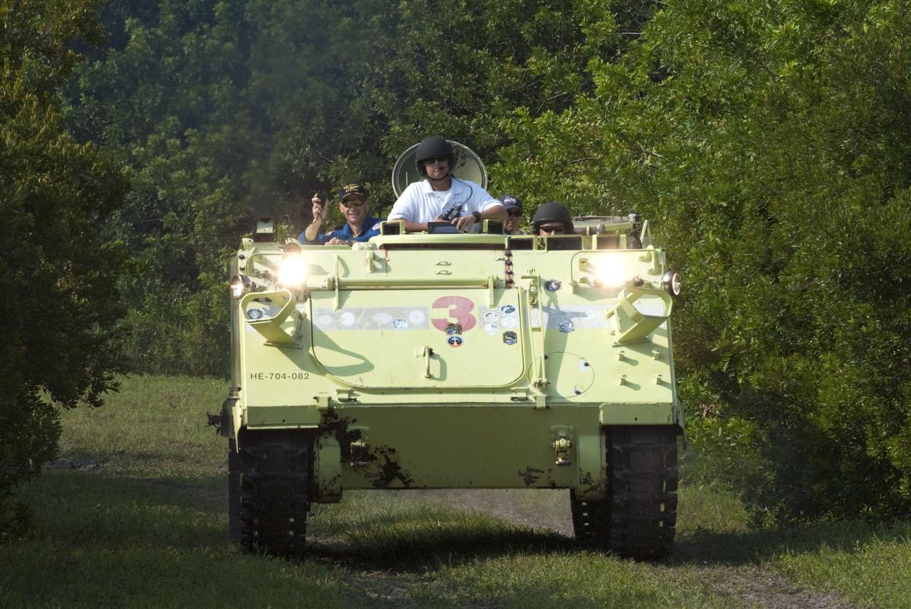 CAPE CANAVERAL, Fla. -- Battalion Chief David Seymour provides supervision while space shuttle Atlantis' STS-135 crew members participate in M113 armored personnel carrier training at NASA's Kennedy Space Center in Florida. Driving the M113 is Pilot Doug Hurley; seated are  Mission Specialist Sandy Magnus (background right) and Commander Chris Ferguson.  An M113 is kept at the foot of the launch pad in case an emergency exit from the launch pad is needed and every shuttle crew is trained on driving the vehicle before launch. The STS-135 crew is at Kennedy to participate in a launch countdown dress rehearsal called the Terminal Countdown Demonstration Test (TCDT) and related training.       Atlantis and its crew are targeted to lift off July 8, taking with them the Raffaello multi-purpose logistics module packed with supplies and spare parts to the International Space Station. The STS-135 mission also will fly a system to investigate the potential for robotically refueling existing satellites and return a failed ammonia pump module to help NASA better understand the failure mechanism and improve pump designs for future systems. STS-135 will be the 33rd flight of Atlantis, the 37th shuttle mission to the space station, and the 135th and final mission of NASA's Space Shuttle Program. For more information visit, www.nasa.gov/mission_pages/shuttle/shuttlemissions/sts135/index.html.  Photo credit: NASA/Kim Shiflett
