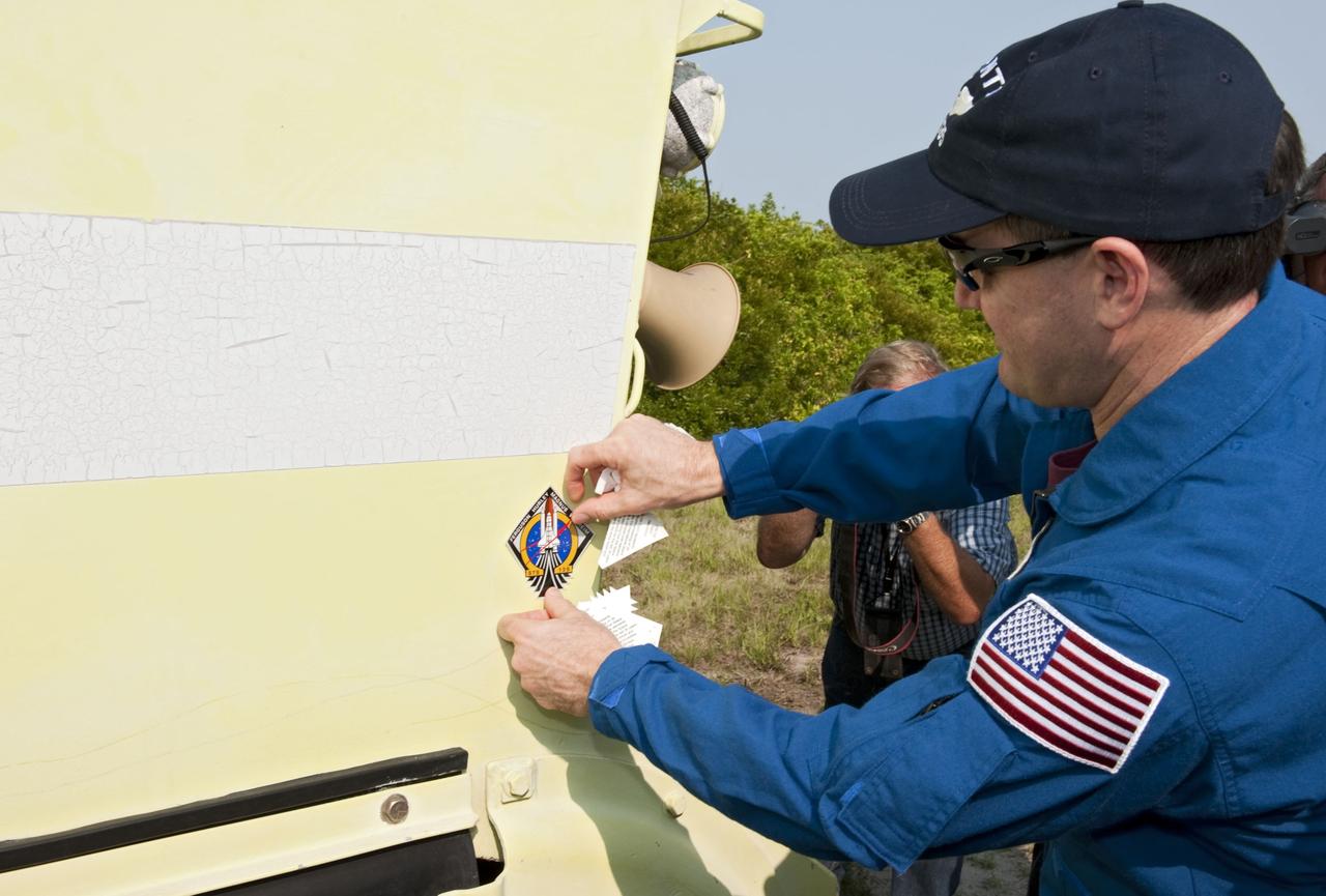 CAPE CANAVERAL, Fla. -- Mission Specialist Rex Walheim affixes his mission's logo on an M113 armored personnel carrier during training at NASA's Kennedy Space Center in Florida . It's tradition for crew members during TCDT to put their mission logo sticker on the M113 they train in. An M113 is kept at the foot of the launch pad in case an emergency exit from the launch pad is needed and every shuttle crew is trained on driving the vehicle before launch. The crew is at Kennedy to participate in a launch countdown dress rehearsal called the Terminal Countdown Demonstration Test (TCDT) and related training. Atlantis and its crew are targeted to lift off July 8, taking with them the Raffaello multi-purpose logistics module packed with supplies and spare parts to the International Space Station. The STS-135 mission also will fly a system to investigate the potential for robotically refueling existing satellites and return a failed ammonia pump module to help NASA better understand the failure mechanism and improve pump designs for future systems. STS-135 will be the 33rd flight of Atlantis, the 37th shuttle mission to the space station, and the 135th and final mission of NASA's Space Shuttle Program. For more information visit, www.nasa.gov/mission_pages/shuttle/shuttlemissions/sts135/index.html. Photo credit: NASA/Kim Shiflett