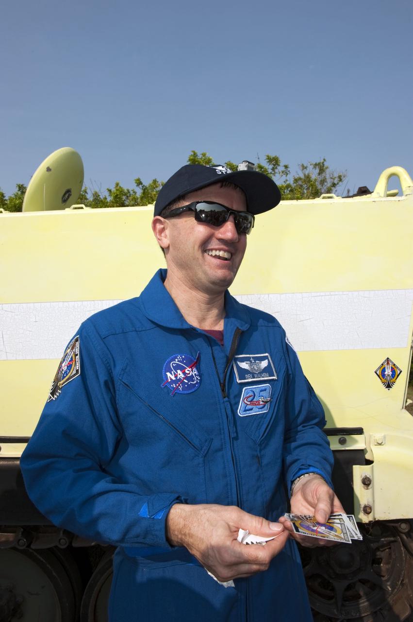 CAPE CANAVERAL, Fla. -- Mission Specialist Rex Walheim holds several of his mission's logos after affixing one on an M113 armored personnel carrier during training at NASA's Kennedy Space Center in Florida . It's tradition for crew members during TCDT to put their mission logo sticker on the M113 they train in. An M113 is kept at the foot of the launch pad in case an emergency exit from the launch pad is needed and every shuttle crew is trained on driving the vehicle before launch. The crew is at Kennedy to participate in a launch countdown dress rehearsal called the Terminal Countdown Demonstration Test (TCDT) and related training. Atlantis and its crew are targeted to lift off July 8, taking with them the Raffaello multi-purpose logistics module packed with supplies and spare parts to the International Space Station. The STS-135 mission also will fly a system to investigate the potential for robotically refueling existing satellites and return a failed ammonia pump module to help NASA better understand the failure mechanism and improve pump designs for future systems. STS-135 will be the 33rd flight of Atlantis, the 37th shuttle mission to the space station, and the 135th and final mission of NASA's Space Shuttle Program. For more information visit, www.nasa.gov/mission_pages/shuttle/shuttlemissions/sts135/index.html. Photo credit: NASA/Kim Shiflett