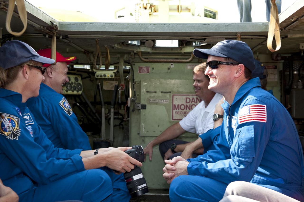 CAPE CANAVERAL, Fla. -- Battalion Chief David Seymour and space shuttle Atlantis' STS-135 crew members enjoy a light moment as they participate in M113 armored personnel carrier training at NASA's Kennedy Space Center in Florida. From left are Mission Specialist Sandy Magnus, Pilot Doug Hurley, Commander Chris Ferguson (obscured) and Mission Specialist Rex Walheim. An M113 is kept at the foot of the launch pad in case an emergency exit from the launch pad is needed and every shuttle crew is trained on driving the vehicle before launch. The STS-135 crew is at Kennedy to participate in a launch countdown dress rehearsal called the Terminal Countdown Demonstration Test (TCDT) and related training.            Atlantis and its crew are targeted to lift off July 8, taking with them the Raffaello multi-purpose logistics module packed with supplies and spare parts to the International Space Station. The STS-135 mission also will fly a system to investigate the potential for robotically refueling existing satellites and return a failed ammonia pump module to help NASA better understand the failure mechanism and improve pump designs for future systems. STS-135 will be the 33rd flight of Atlantis, the 37th shuttle mission to the space station, and the 135th and final mission of NASA's Space Shuttle Program. For more information visit, www.nasa.gov/mission_pages/shuttle/shuttlemissions/sts135/index.html. Photo credit: NASA/Kim Shiflett
