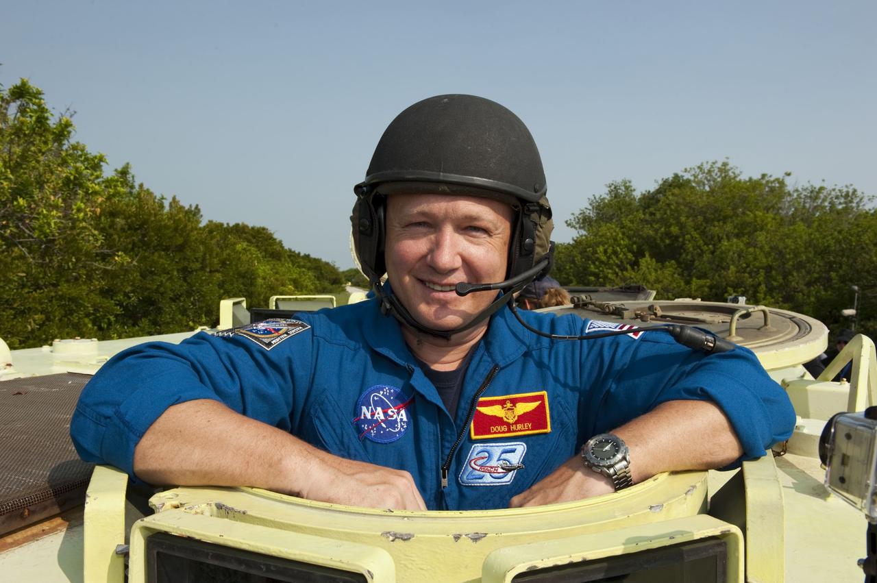 CAPE CANAVERAL, Fla. -- Pilot Doug Hurley pauses for a photo during M113 armored personnel carrier training at NASA's Kennedy Space Center in Florida. An M113 is kept at the foot of the launch pad in case an emergency exit from the launch pad is needed and every shuttle crew is trained on driving the vehicle before launch. The STS-135 crew is at Kennedy to participate in a launch countdown dress rehearsal called the Terminal Countdown Demonstration Test (TCDT) and related training. Atlantis and its crew are targeted to lift off July 8, taking with them the Raffaello multi-purpose logistics module packed with supplies and spare parts to the International Space Station. The STS-135 mission also will fly a system to investigate the potential for robotically refueling existing satellites and return a failed ammonia pump module to help NASA better understand the failure mechanism and improve pump designs for future systems. STS-135 will be the 33rd flight of Atlantis, the 37th shuttle mission to the space station, and the 135th and final mission of NASA's Space Shuttle Program. For more information visit, www.nasa.gov/mission_pages/shuttle/shuttlemissions/sts135/index.html. Photo credit: NASA/Kim Shiflett