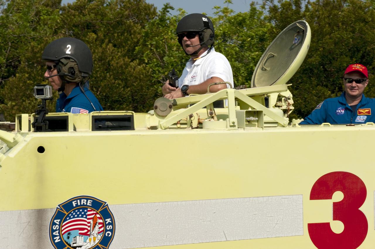 CAPE CANAVERAL, Fla. -- Battalion Chief David Seymour provides supervision while space shuttle Atlantis' STS-135 crew members participate in M113 armored personnel carrier training at NASA's Kennedy Space Center in Florida. Driving the M113 is Mission Specialist Sandy Magnus while Pilot Doug Hurley looks on. An M113 is kept at the foot of the launch pad in case an emergency exit from the launch pad is needed and every shuttle crew is trained on driving the vehicle before launch. The STS-135 crew is at Kennedy to participate in a launch countdown dress rehearsal called the Terminal Countdown Demonstration Test (TCDT) and related training.           Atlantis and its crew are targeted to lift off July 8, taking with them the Raffaello multi-purpose logistics module packed with supplies and spare parts to the International Space Station. The STS-135 mission also will fly a system to investigate the potential for robotically refueling existing satellites and return a failed ammonia pump module to help NASA better understand the failure mechanism and improve pump designs for future systems. STS-135 will be the 33rd flight of Atlantis, the 37th shuttle mission to the space station, and the 135th and final mission of NASA's Space Shuttle Program. For more information visit, www.nasa.gov/mission_pages/shuttle/shuttlemissions/sts135/index.html. Photo credit: NASA/Kim Shiflett