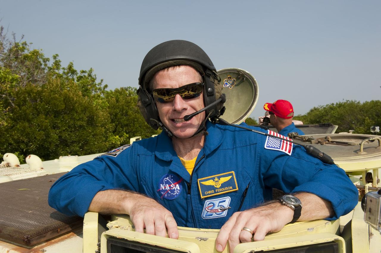 CACAPE CANAVERAL, Fla. -- Commander Chris Ferguson pauses for a photo during M113 armored personnel carrier training at NASA's Kennedy Space Center in Florida. An M113 is kept at the foot of the launch pad in case an emergency exit from the launch pad is needed and every shuttle crew is trained on driving the vehicle before launch. The STS-135 crew is at Kennedy to participate in a launch countdown dress rehearsal called the Terminal Countdown Demonstration Test (TCDT) and related training. Atlantis and its crew are targeted to lift off July 8, taking with them the Raffaello multi-purpose logistics module packed with supplies and spare parts to the International Space Station. The STS-135 mission also will fly a system to investigate the potential for robotically refueling existing satellites and return a failed ammonia pump module to help NASA better understand the failure mechanism and improve pump designs for future systems. STS-135 will be the 33rd flight of Atlantis, the 37th shuttle mission to the space station, and the 135th and final mission of NASA's Space Shuttle Program. For more information visit, www.nasa.gov/mission_pages/shuttle/shuttlemissions/sts135/index.html. Photo credit: NASA/Kim Shiflett