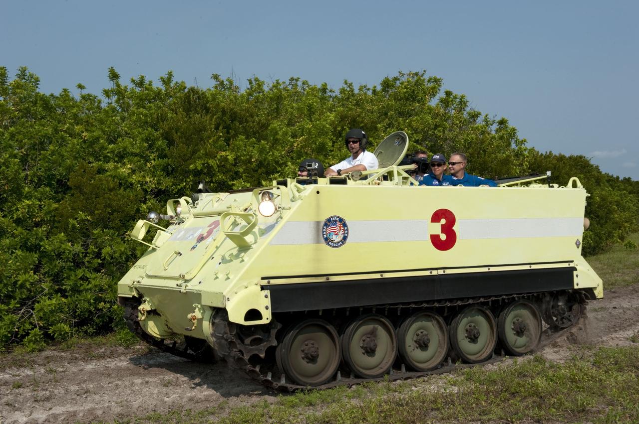 CAPE CANAVERAL, Fla. -- Battalion Chief David Seymour provides supervision while space shuttle Atlantis' STS-135 crew members participate in M113 armored personnel carrier training at NASA's Kennedy Space Center in Florida. An M113 is kept at the foot of the launch pad in case an emergency exit from the launch pad is needed and every shuttle crew is trained on driving the vehicle before launch. The STS-135 crew is at Kennedy to participate in a launch countdown dress rehearsal called the Terminal Countdown Demonstration Test (TCDT) and related training.         Atlantis and its crew are targeted to lift off July 8, taking with them the Raffaello multi-purpose logistics module packed with supplies and spare parts to the International Space Station. The STS-135 mission also will fly a system to investigate the potential for robotically refueling existing satellites and return a failed ammonia pump module to help NASA better understand the failure mechanism and improve pump designs for future systems. STS-135 will be the 33rd flight of Atlantis, the 37th shuttle mission to the space station, and the 135th and final mission of NASA's Space Shuttle Program. For more information visit, www.nasa.gov/mission_pages/shuttle/shuttlemissions/sts135/index.html. Photo credit: NASA/Kim Shiflett