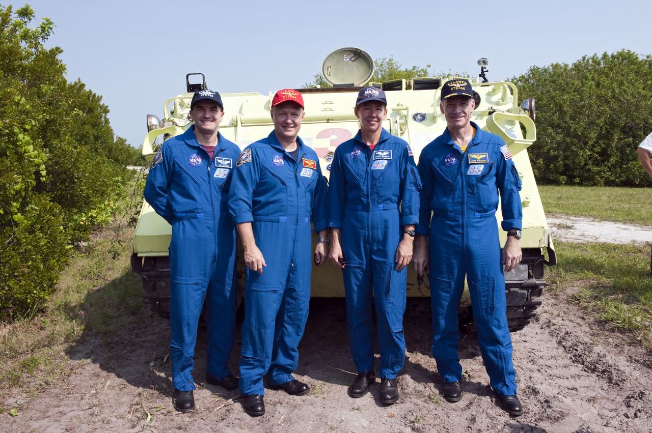 CAPE CANAVERAL, Fla. -- The STS-135 crew pause for a photo at the conclusion of their M113 armored personnel carrier training at NASA's Kennedy Space Center in Florida. Seen here are Mission Specialist Rex Walheim (left), Pilot Doug Hurley, Mission Specialist Sandy Magnus and Commander Chris Ferguson. An M113 is kept at the foot of the launch pad in case an emergency exit from the launch pad is needed and every shuttle crew is trained on driving the vehicle before launch. The STS-135 crew is at Kennedy to participate in a launch countdown dress rehearsal called the Terminal Countdown Demonstration Test (TCDT) and related training.         Atlantis and its crew are targeted to lift off July 8, taking with them the Raffaello multi-purpose logistics module packed with supplies and spare parts to the International Space Station. The STS-135 mission also will fly a system to investigate the potential for robotically refueling existing satellites and return a failed ammonia pump module to help NASA better understand the failure mechanism and improve pump designs for future systems. STS-135 will be the 33rd flight of Atlantis, the 37th shuttle mission to the space station, and the 135th and final mission of NASA's Space Shuttle Program. For more information visit, www.nasa.gov/mission_pages/shuttle/shuttlemissions/sts135/index.html. Photo credit: NASA/Kim Shiflett