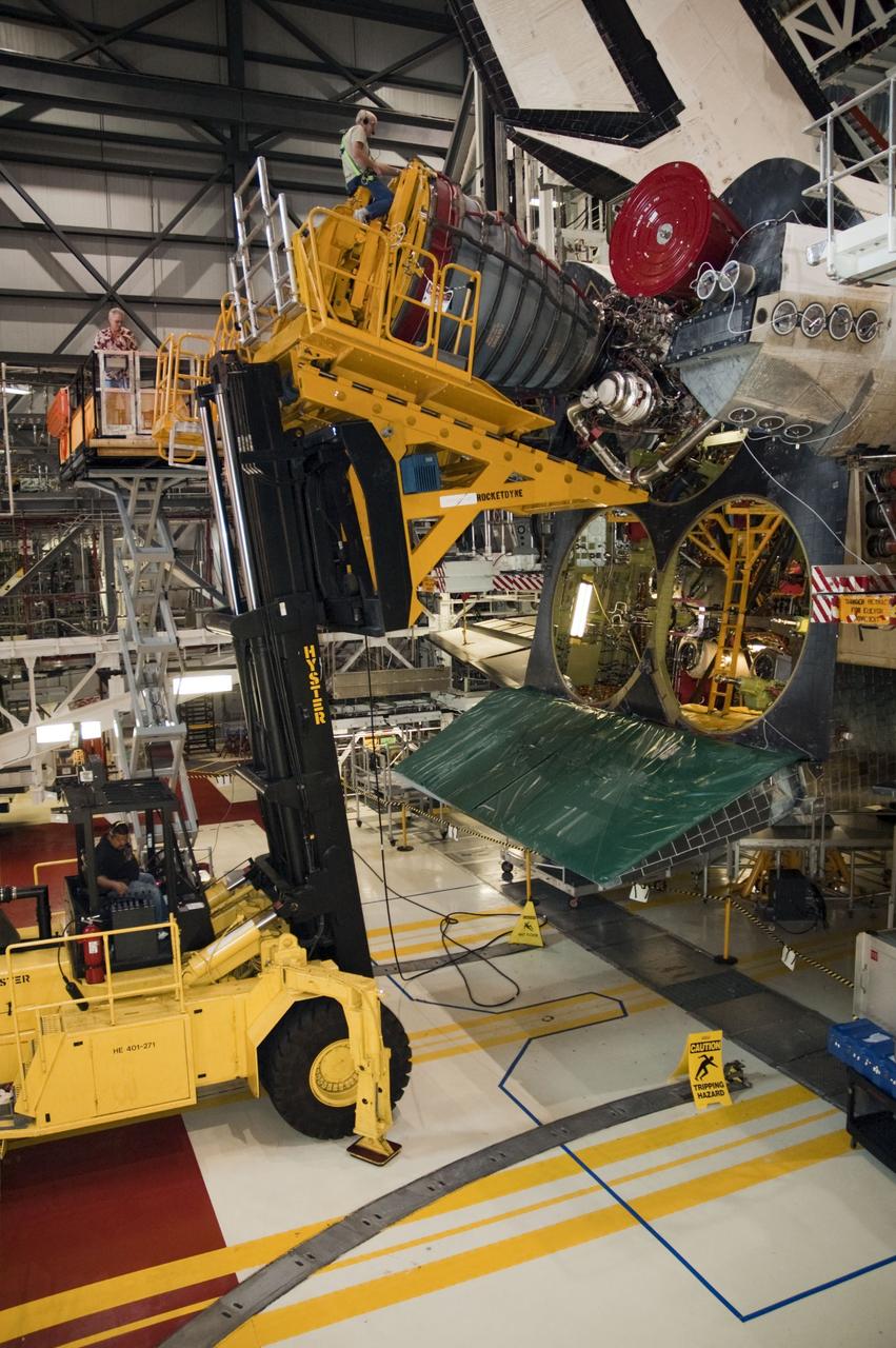 CAPE CANAVERAL, Fla. -- In Orbiter Processing Facility-1 at NASA's Kennedy Space Center in Florida, technicians remove engine No. 1, one of three space shuttle main engines from shuttle Endeavour using a specially designed engine installer, called a Hyster forklift. The work is part of Endeavour's transition and retirement processing. The spacecraft is being prepared for public display at the California Science Center in Los Angeles. Endeavour flew 25 missions, spent 299 days in space, orbited Earth 4,671 times and traveled 122,883,151 miles over the course of its 19-year career. Endeavour's STS-134 and final mission was completed after landing on June 1, 2011. Photo credit: NASA/Chris Chamberland