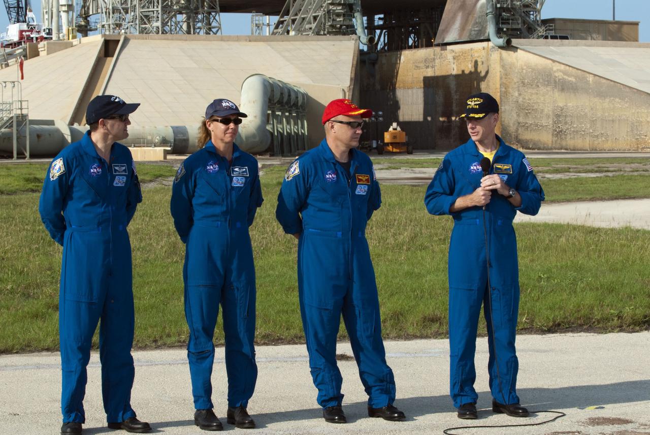 CAPE CANAVERAL, Fla. -- The STS-135 crew members gather at NASA Kennedy Space Center's Launch Pad 39A in Florida for a question-and-answer session with media. With the microphone in hand is Commander Chris Ferguson as Pilot Doug Hurley, Mission Specialists Sandy Magnus and Rex Walheim look on. Space shuttle Atlantis' astronauts are at Kennedy to participate in a launch countdown dress rehearsal called the Terminal Countdown Demonstration Test (TCDT) and related training.                Atlantis and its crew are targeted to lift off July 8, taking with them the Raffaello multi-purpose logistics module packed with supplies and spare parts to the International Space Station. The STS-135 mission also will fly a system to investigate the potential for robotically refueling existing satellites and return a failed ammonia pump module to help NASA better understand the failure mechanism and improve pump designs for future systems. STS-135 will be the 33rd flight of Atlantis, the 37th shuttle mission to the space station, and the 135th and final mission of NASA's Space Shuttle Program. For more information visit, www.nasa.gov/mission_pages/shuttle/shuttlemissions/sts135/index.html. Photo credit: NASA/Kim Shiflett