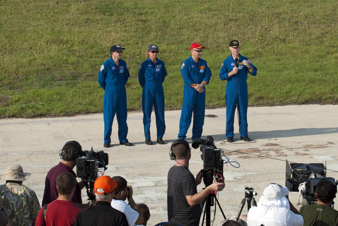 CAPE CANAVERAL, Fla. -- The STS-135 crew members gather at NASA Kennedy Space Center's Launch Pad 39A in Florida for a question-and-answer session with media. With the microphone in hand is Commander Chris Ferguson as Pilot Doug Hurley, Mission Specialists Sandy Magnus and Rex Walheim look on. Space shuttle Atlantis' astronauts are at Kennedy to participate in a launch countdown dress rehearsal called the Terminal Countdown Demonstration Test (TCDT) and related training.                Atlantis and its crew are targeted to lift off July 8, taking with them the Raffaello multi-purpose logistics module packed with supplies and spare parts to the International Space Station. The STS-135 mission also will fly a system to investigate the potential for robotically refueling existing satellites and return a failed ammonia pump module to help NASA better understand the failure mechanism and improve pump designs for future systems. STS-135 will be the 33rd flight of Atlantis, the 37th shuttle mission to the space station, and the 135th and final mission of NASA's Space Shuttle Program. For more information visit, www.nasa.gov/mission_pages/shuttle/shuttlemissions/sts135/index.html. Photo credit: NASA/Kim Shiflett