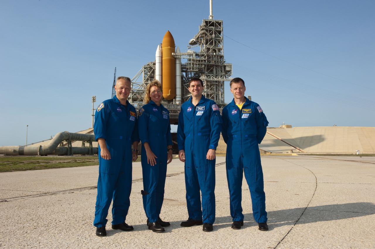 CAPE CANAVERAL, Fla. -- The STS-135 crew members stand for a photograph before a question-and-answer session with media at NASA Kennedy Space Center's Launch Pad 39A in Florida. From left are Pilot Doug Hurley, Mission Specialists Sandy Magnus and Rex Walheim, and Commander Chris Ferguson. Space shuttle Atlantis' astronauts are at Kennedy to participate in a launch countdown dress rehearsal called the Terminal Countdown Demonstration Test (TCDT) and related training.        Atlantis and its crew are targeted to lift off July 8, taking with them the Raffaello multi-purpose logistics module packed with supplies and spare parts to the International Space Station. The STS-135 mission also will fly a system to investigate the potential for robotically refueling existing satellites and return a failed ammonia pump module to help NASA better understand the failure mechanism and improve pump designs for future systems. STS-135 will be the 33rd flight of Atlantis, the 37th shuttle mission to the space station, and the 135th and final mission of NASA's Space Shuttle Program. For more information visit, www.nasa.gov/mission_pages/shuttle/shuttlemissions/sts135/index.html. Photo credit: NASA/Kim Shiflett