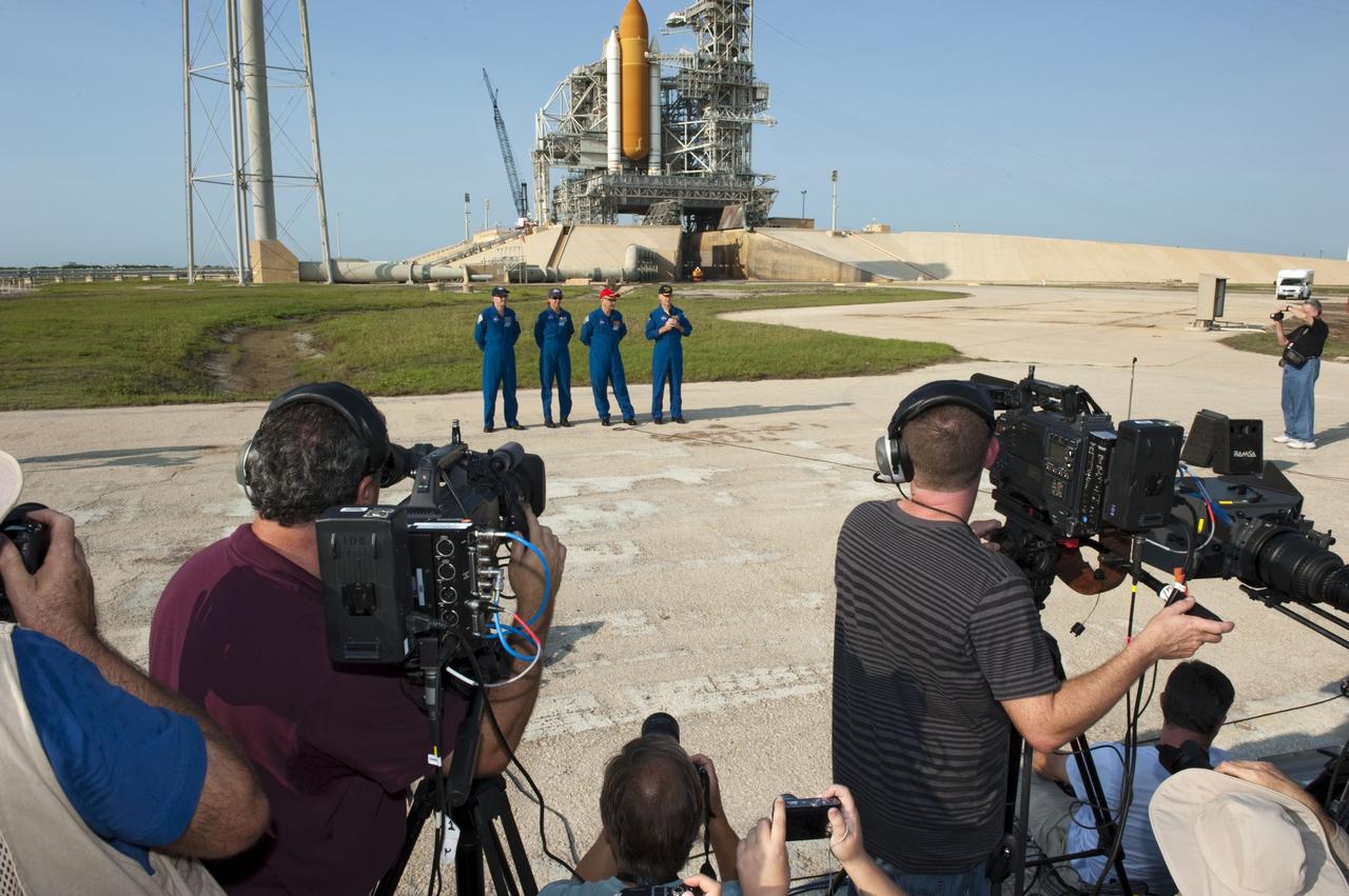CAPE CANAVERAL, Fla. -- The STS-135 crew members gather at NASA Kennedy Space Center's Launch Pad 39A in Florida for a question-and-answer session with media. With the microphone in hand is Commander Chris Ferguson as Pilot Doug Hurley (red cap), Mission Specialists Sandy Magnus and Rex Walheim look on. Space shuttle Atlantis' astronauts are at Kennedy to participate in a launch countdown dress rehearsal called the Terminal Countdown Demonstration Test (TCDT) and related training.        Atlantis and its crew are targeted to lift off July 8, taking with them the Raffaello multi-purpose logistics module packed with supplies and spare parts to the International Space Station. The STS-135 mission also will fly a system to investigate the potential for robotically refueling existing satellites and return a failed ammonia pump module to help NASA better understand the failure mechanism and improve pump designs for future systems. STS-135 will be the 33rd flight of Atlantis, the 37th shuttle mission to the space station, and the 135th and final mission of NASA's Space Shuttle Program. For more information visit, www.nasa.gov/mission_pages/shuttle/shuttlemissions/sts135/index.html. Photo credit: NASA/Kim Shiflett