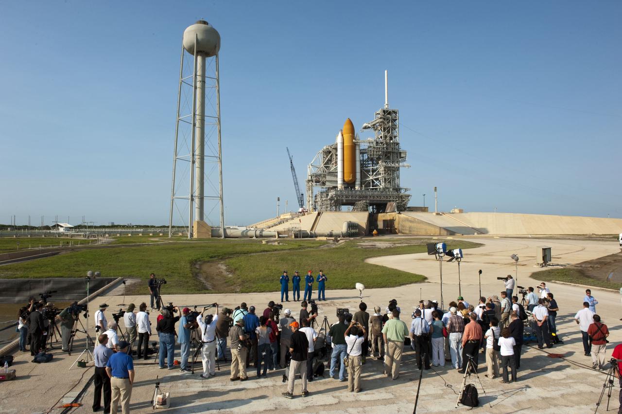 CAPE CANAVERAL, Fla. -- The STS-135 crew members gather at NASA Kennedy Space Center's Launch Pad 39A in Florida for a question-and-answer session with media. With the microphone in hand is Commander Chris Ferguson as Pilot Doug Hurley (red cap), Mission Specialists Sandy Magnus and Rex Walheim look on. Space shuttle Atlantis' astronauts are at Kennedy to participate in a launch countdown dress rehearsal called the Terminal Countdown Demonstration Test (TCDT) and related training.      Atlantis and its crew are targeted to lift off July 8, taking with them the Raffaello multi-purpose logistics module packed with supplies and spare parts to the International Space Station. The STS-135 mission also will fly a system to investigate the potential for robotically refueling existing satellites and return a failed ammonia pump module to help NASA better understand the failure mechanism and improve pump designs for future systems. STS-135 will be the 33rd flight of Atlantis, the 37th shuttle mission to the space station, and the 135th and final mission of NASA's Space Shuttle Program. For more information visit, www.nasa.gov/mission_pages/shuttle/shuttlemissions/sts135/index.html. Photo credit: NASA/Kim Shiflett