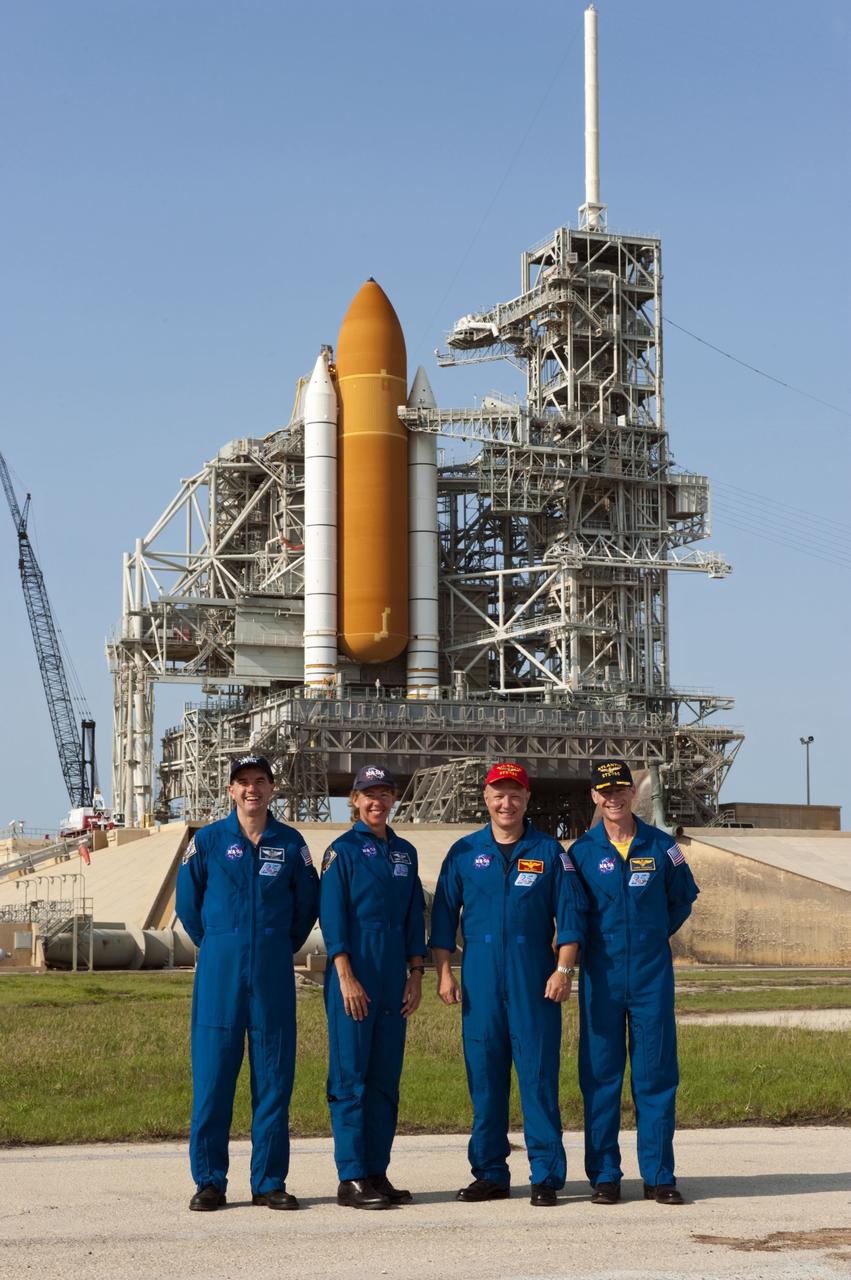 CAPE CANAVERAL, Fla. -- The STS-135 crew members stand for a photograph after a question-and-answer session with media at NASA Kennedy Space Center's Launch Pad 39A in Florida. From left are Mission Specialists Rex Walheim and Sandy Magnus; Pilot Doug Hurley and Commander Chris Ferguson. Space shuttle Atlantis' astronauts are at Kennedy to participate in a launch countdown dress rehearsal called the Terminal Countdown Demonstration Test (TCDT) and related training.            Atlantis and its crew are targeted to lift off July 8, taking with them the Raffaello multi-purpose logistics module packed with supplies and spare parts to the International Space Station. The STS-135 mission also will fly a system to investigate the potential for robotically refueling existing satellites and return a failed ammonia pump module to help NASA better understand the failure mechanism and improve pump designs for future systems. STS-135 will be the 33rd flight of Atlantis, the 37th shuttle mission to the space station, and the 135th and final mission of NASA's Space Shuttle Program. For more information visit, www.nasa.gov/mission_pages/shuttle/shuttlemissions/sts135/index.html. Photo credit: NASA/Kim Shiflett