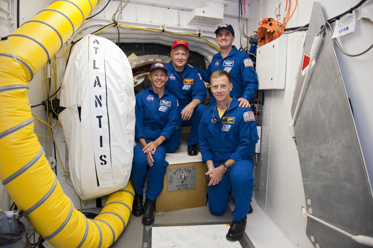 CAPE CANAVERAL, Fla. -- At Launch Pad 39A at NASA's Kennedy Space Center in Florida, the STS-135 crew pose for a group portrait in front of space shuttle Atlantis' hatch in the pad's White Room. From left are Mission Specialist Sandy Magnus, Pilot Doug Hurley, Mission Specialist Rex Walheim and Commander Chris Ferguson. An access arm supports the White Room that is in place against the shuttle which provides entry to the crew compartment. The astronauts are at Kennedy to participate in a launch countdown dress rehearsal called the Terminal Countdown Demonstration Test (TCDT) and related training. Atlantis and its crew are targeted to lift off July 8, taking with them the Raffaello multi-purpose logistics module packed with supplies and spare parts to the International Space Station. The STS-135 mission also will fly a system to investigate the potential for robotically refueling existing satellites and return a failed ammonia pump module to help NASA better understand the failure mechanism and improve pump designs for future systems. STS-135 will be the 33rd flight of Atlantis, the 37th shuttle mission to the space station, and the 135th and final mission of NASA's Space Shuttle Program. For more information visit, www.nasa.gov/mission_pages/shuttle/shuttlemissions/sts135/index.html. Photo credit: NASA/Kim Shiflett