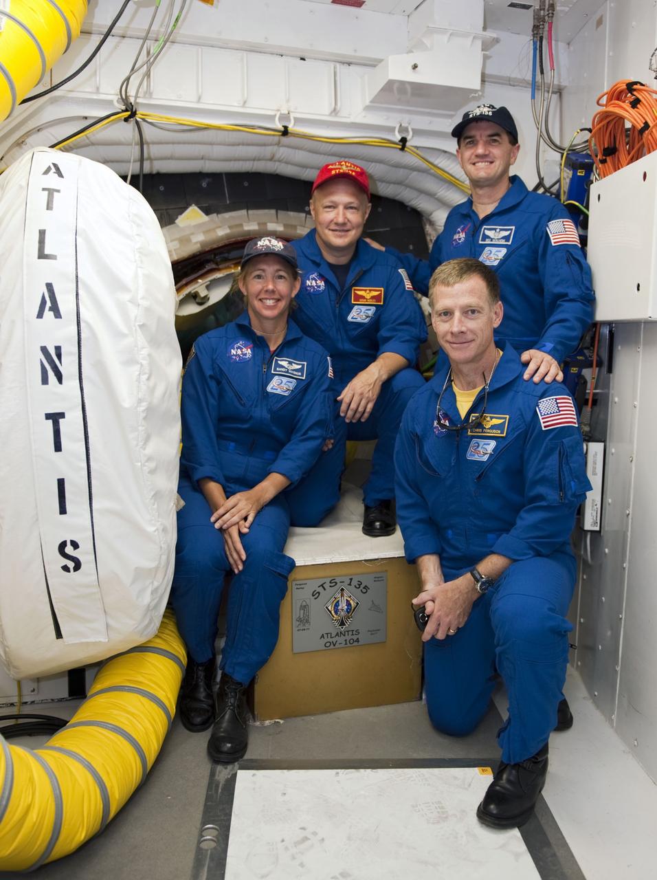 CAPE CANAVERAL, Fla. -- At Launch Pad 39A at NASA's Kennedy Space Center in Florida, the STS-135 crew pose for a group portrait in front of space shuttle Atlantis' hatch in the pad's White Room. From left are Mission Specialist Sandy Magnus, Pilot Doug Hurley, Mission Specialist Rex Walheim and Commander Chris Ferguson. An access arm supports the White Room that is in place against the shuttle which provides entry to the crew compartment. The astronauts are at Kennedy to participate in a launch countdown dress rehearsal called the Terminal Countdown Demonstration Test (TCDT) and related training. Atlantis and its crew are targeted to lift off July 8, taking with them the Raffaello multi-purpose logistics module packed with supplies and spare parts to the International Space Station. The STS-135 mission also will fly a system to investigate the potential for robotically refueling existing satellites and return a failed ammonia pump module to help NASA better understand the failure mechanism and improve pump designs for future systems. STS-135 will be the 33rd flight of Atlantis, the 37th shuttle mission to the space station, and the 135th and final mission of NASA's Space Shuttle Program. For more information visit, www.nasa.gov/mission_pages/shuttle/shuttlemissions/sts135/index.html. Photo credit: NASA/Kim Shiflett