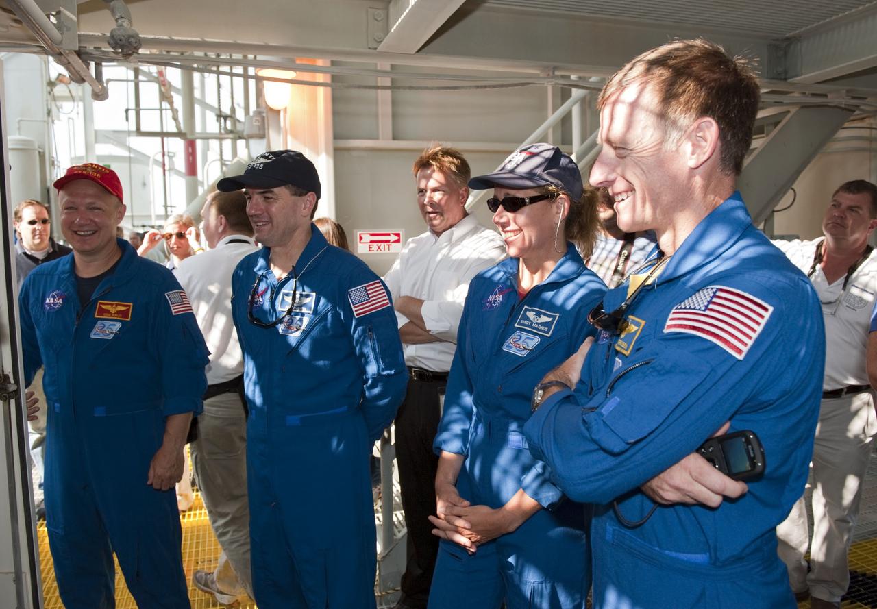 CAPE CANAVERAL, Fla. -- On Launch Pad 39A at NASA's Kennedy Space Center in Florida, members of space shuttle Atlantis' STS-135 crew are instructed on emergency exit procedures. From left are Pilot Doug Hurley, Mission Specialists Rex Walheim and Sandy Magnus, and Commander Chris Ferguson. Also seen in this image is NASA Test Director Jeff Spaulding (center). The astronauts are at Kennedy to participate in a launch countdown dress rehearsal called the Terminal Countdown Demonstration Test (TCDT) and related training. Atlantis and its crew are targeted to lift off July 8, taking with them the Raffaello multi-purpose logistics module packed with supplies and spare parts to the International Space Station. The STS-135 mission also will fly a system to investigate the potential for robotically refueling existing satellites and return a failed ammonia pump module to help NASA better understand the failure mechanism and improve pump designs for future systems. STS-135 will be the 33rd flight of Atlantis, the 37th shuttle mission to the space station, and the 135th and final mission of NASA's Space Shuttle Program. For more information visit, www.nasa.gov/mission_pages/shuttle/shuttlemissions/sts135/index.html. Photo credit: NASA/Kim Shiflett