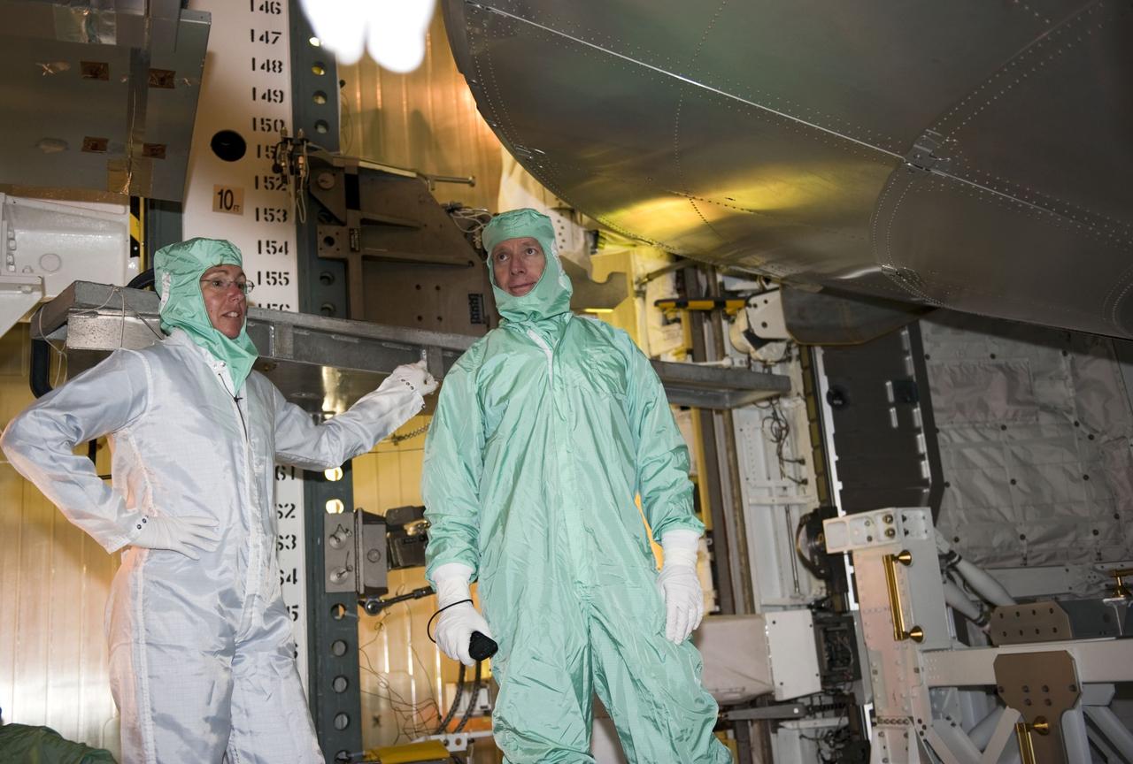 CAPE CANAVERAL, Fla. -- At Launch Pad 39A at NASA's Kennedy Space Center in Florida, space shuttle Atlantis' STS-135 crew members take part in a payload bay walkdown to check out the cargo secured in Atlantis' bay. Seen here are Mission Specialist Sandy Magnus (left) and Commander Chris Ferguson.      The astronauts are at Kennedy to participate in a launch countdown dress rehearsal called the Terminal Countdown Demonstration Test (TCDT) and related training. Atlantis and its crew are targeted to lift off July 8, taking with them the Raffaello multi-purpose logistics module packed with supplies and spare parts to the International Space Station. The STS-135 mission also will fly a system to investigate the potential for robotically refueling existing satellites and return a failed ammonia pump module to help NASA better understand the failure mechanism and improve pump designs for future systems. STS-135 will be the 33rd flight of Atlantis, the 37th shuttle mission to the space station, and the 135th and final mission of NASA's Space Shuttle Program. For more information visit, www.nasa.gov/mission_pages/shuttle/shuttlemissions/sts135/index.html. Photo credit: NASA/Kim Shiflett