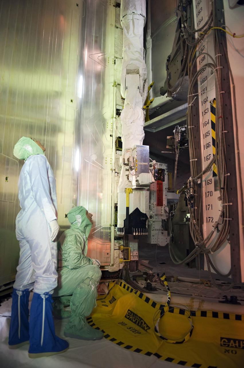 CAPE CANAVERAL, Fla. -- At Launch Pad 39A at NASA's Kennedy Space Center in Florida, space shuttle Atlantis' STS-135 crew members take part in a payload bay walkdown to check out the cargo secured in Atlantis' bay. Seen here are Mission Specialist Sandy Magnus (left) and Commander Chris Ferguson.    The astronauts are at Kennedy to participate in a launch countdown dress rehearsal called the Terminal Countdown Demonstration Test (TCDT) and related training. Atlantis and its crew are targeted to lift off July 8, taking with them the Raffaello multi-purpose logistics module packed with supplies and spare parts to the International Space Station. The STS-135 mission also will fly a system to investigate the potential for robotically refueling existing satellites and return a failed ammonia pump module to help NASA better understand the failure mechanism and improve pump designs for future systems. STS-135 will be the 33rd flight of Atlantis, the 37th shuttle mission to the space station, and the 135th and final mission of NASA's Space Shuttle Program. For more information visit, www.nasa.gov/mission_pages/shuttle/shuttlemissions/sts135/index.html. Photo credit: NASA/Kim Shiflett