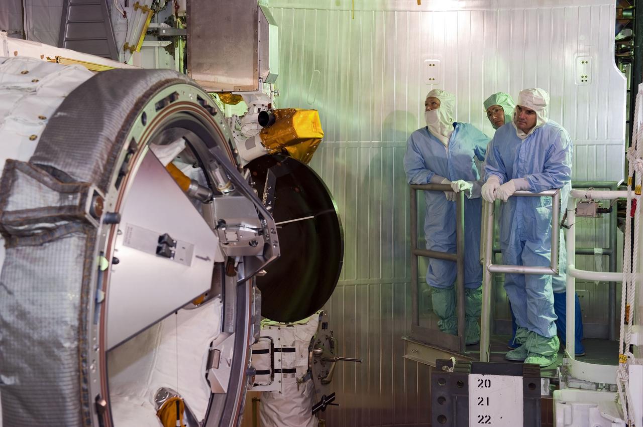 CAPE CANAVERAL, Fla. -- At Launch Pad 39A at NASA's Kennedy Space Center in Florida, space shuttle Atlantis' STS-135 crew members take part in a payload bay walkdown to check out the cargo secured in Atlantis' bay. Seen here inspecting the airlock are Pilot Doug Hurley (left), and Mission Specialists Sandy Magnus and Rex Walheim.  The astronauts are at Kennedy to participate in a launch countdown dress rehearsal called the Terminal Countdown Demonstration Test (TCDT) and related training. Atlantis and its crew are targeted to lift off July 8, taking with them the Raffaello multi-purpose logistics module packed with supplies and spare parts to the International Space Station. The STS-135 mission also will fly a system to investigate the potential for robotically refueling existing satellites and return a failed ammonia pump module to help NASA better understand the failure mechanism and improve pump designs for future systems. STS-135 will be the 33rd flight of Atlantis, the 37th shuttle mission to the space station, and the 135th and final mission of NASA's Space Shuttle Program. For more information visit, www.nasa.gov/mission_pages/shuttle/shuttlemissions/sts135/index.html. Photo credit: NASA/Kim Shiflett