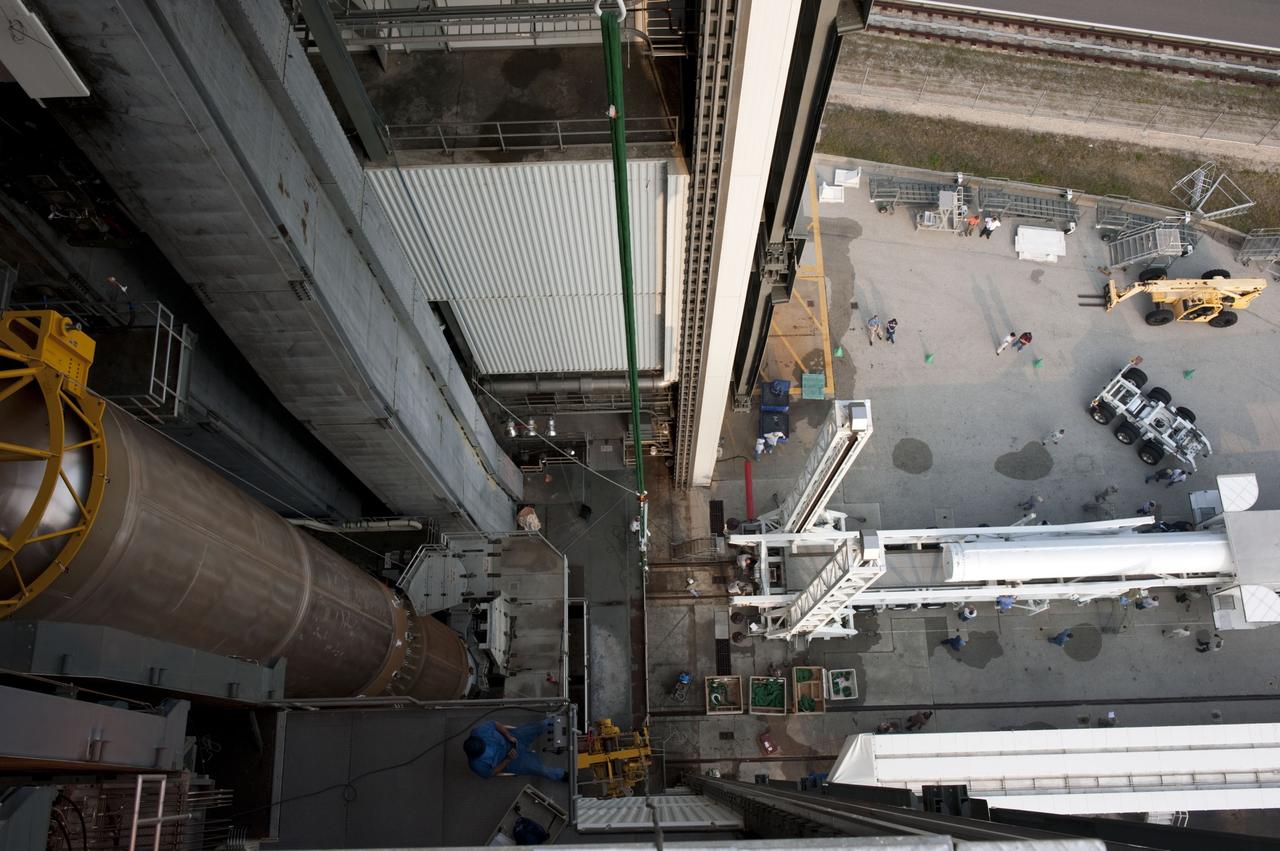 CAPE CANAVERAL, Fla. -- At Cape Canaveral Air Force Station in Florida, workers prepare a solid rocket motor for lifting into the Vertical Integration Facility at Launch Complex 41. It then will be attached to the United Launch Alliance Atlas V booster stage, already at the pad. NASA's Juno spacecraft is scheduled to launch aboard an Atlas V from Cape Canaveral, Fla. Aug. 5.The solar-powered spacecraft will orbit Jupiter's poles 33 times to find out more about the gas giant's origins, structure, atmosphere and magnetosphere and investigate the existence of a solid planetary core. For more information visit: www.nasa.gov/juno. Photo credit: NASA/Kim Shiflett
