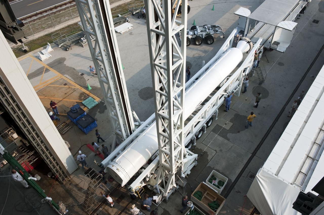 CAPE CANAVERAL, Fla. -- At Cape Canaveral Air Force Station in Florida, workers prepare a solid rocket motor for lifting into the Vertical Integration Facility at Launch Complex 41. It then will be attached to the United Launch Alliance Atlas V booster stage, already at the pad. NASA's Juno spacecraft is scheduled to launch aboard an Atlas V from Cape Canaveral, Fla. Aug. 5.The solar-powered spacecraft will orbit Jupiter's poles 33 times to find out more about the gas giant's origins, structure, atmosphere and magnetosphere and investigate the existence of a solid planetary core. For more information visit: www.nasa.gov/juno. Photo credit: NASA/Kim Shiflett