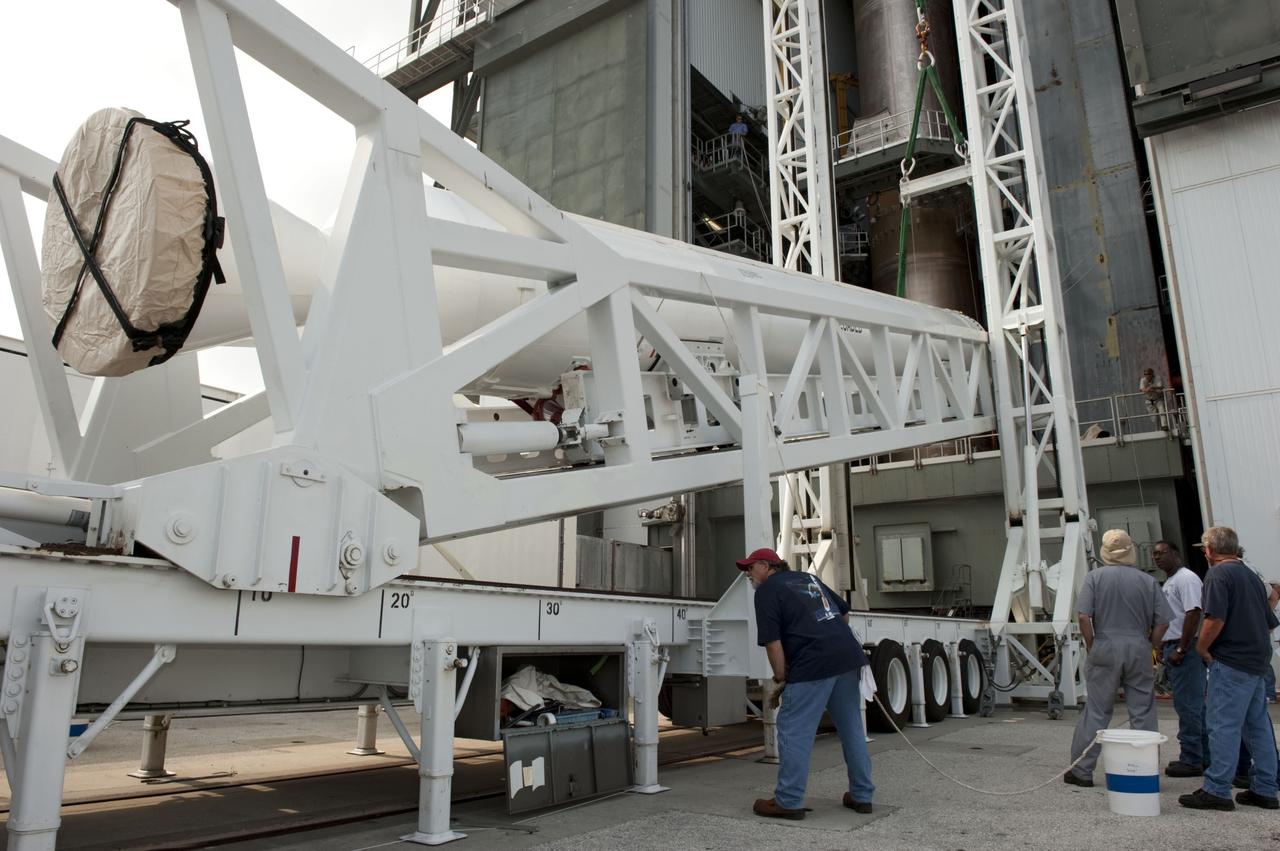 CAPE CANAVERAL, Fla. -- At Cape Canaveral Air Force Station in Florida, workers using an overhead crane lift a solid rocket motor into the Vertical Integration Facility at Launch Complex 41. It then will be attached to the United Launch Alliance Atlas V booster stage, already at the pad. NASA's Juno spacecraft is scheduled to launch aboard an Atlas V from Cape Canaveral, Fla. Aug. 5.The solar-powered spacecraft will orbit Jupiter's poles 33 times to find out more about the gas giant's origins, structure, atmosphere and magnetosphere and investigate the existence of a solid planetary core. For more information visit: www.nasa.gov/juno. Photo credit: NASA/Kim Shiflett