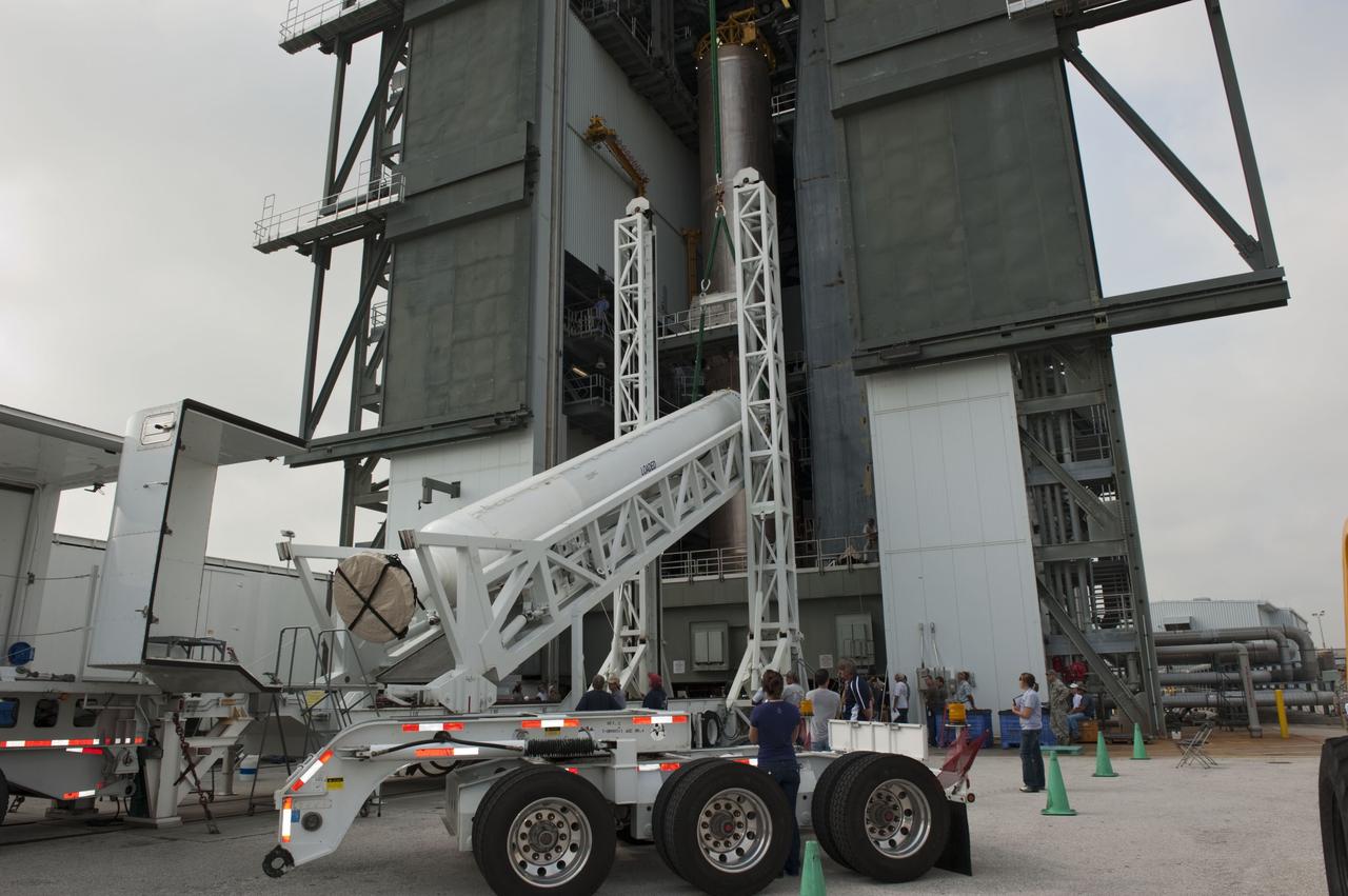 CAPE CANAVERAL, Fla. -- At Cape Canaveral Air Force Station in Florida, workers using an overhead crane lift a solid rocket motor into the Vertical Integration Facility at Launch Complex 41. It then will be attached to the United Launch Alliance Atlas V booster stage, already at the pad. NASA's Juno spacecraft is scheduled to launch aboard an Atlas V from Cape Canaveral, Fla. Aug. 5.The solar-powered spacecraft will orbit Jupiter's poles 33 times to find out more about the gas giant's origins, structure, atmosphere and magnetosphere and investigate the existence of a solid planetary core. For more information visit: www.nasa.gov/juno. Photo credit: NASA/Kim Shiflett