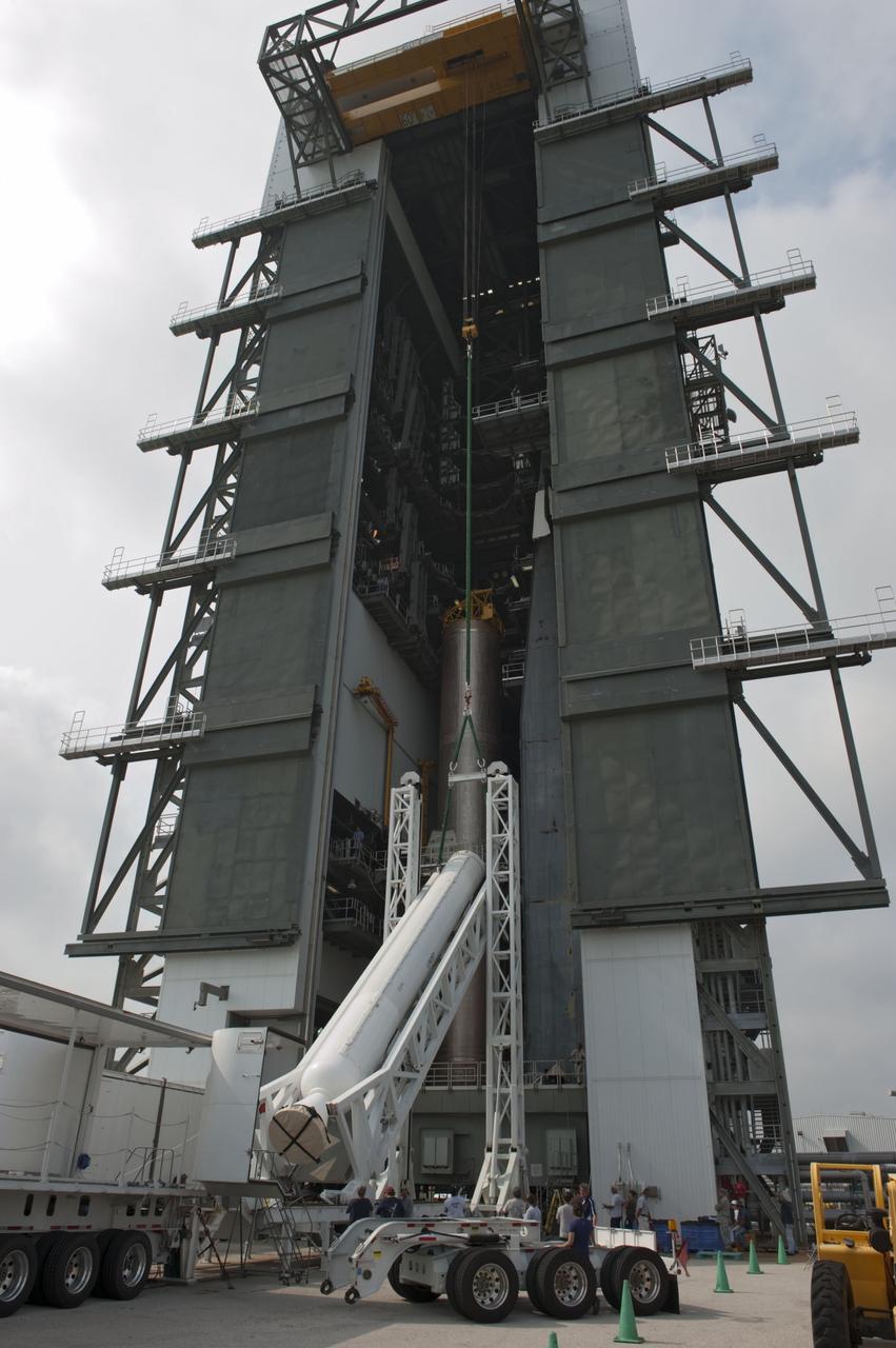 CAPE CANAVERAL, Fla. -- At Cape Canaveral Air Force Station in Florida, workers using an overhead crane lift a solid rocket motor into the Vertical Integration Facility at Launch Complex 41. It then will be attached to the United Launch Alliance Atlas V booster stage, already at the pad. NASA's Juno spacecraft is scheduled to launch aboard an Atlas V from Cape Canaveral, Fla. Aug. 5.The solar-powered spacecraft will orbit Jupiter's poles 33 times to find out more about the gas giant's origins, structure, atmosphere and magnetosphere and investigate the existence of a solid planetary core. For more information visit: www.nasa.gov/juno. Photo credit: NASA/Kim Shiflett