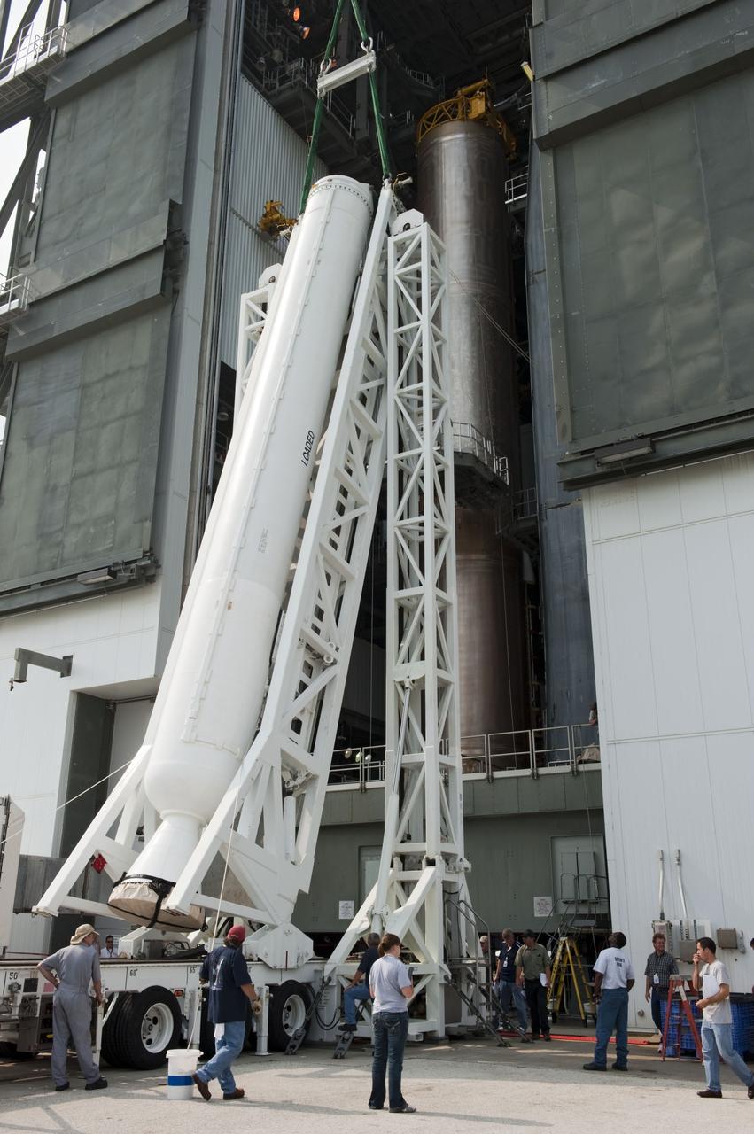 CAPE CANAVERAL, Fla. -- At Cape Canaveral Air Force Station in Florida, workers using an overhead crane lift a solid rocket motor into the Vertical Integration Facility at Launch Complex 41. It then will be attached to the United Launch Alliance Atlas V booster stage, already at the pad. NASA's Juno spacecraft is scheduled to launch aboard an Atlas V from Cape Canaveral, Fla. Aug. 5.The solar-powered spacecraft will orbit Jupiter's poles 33 times to find out more about the gas giant's origins, structure, atmosphere and magnetosphere and investigate the existence of a solid planetary core. For more information visit: www.nasa.gov/juno. Photo credit: NASA/Kim Shiflett