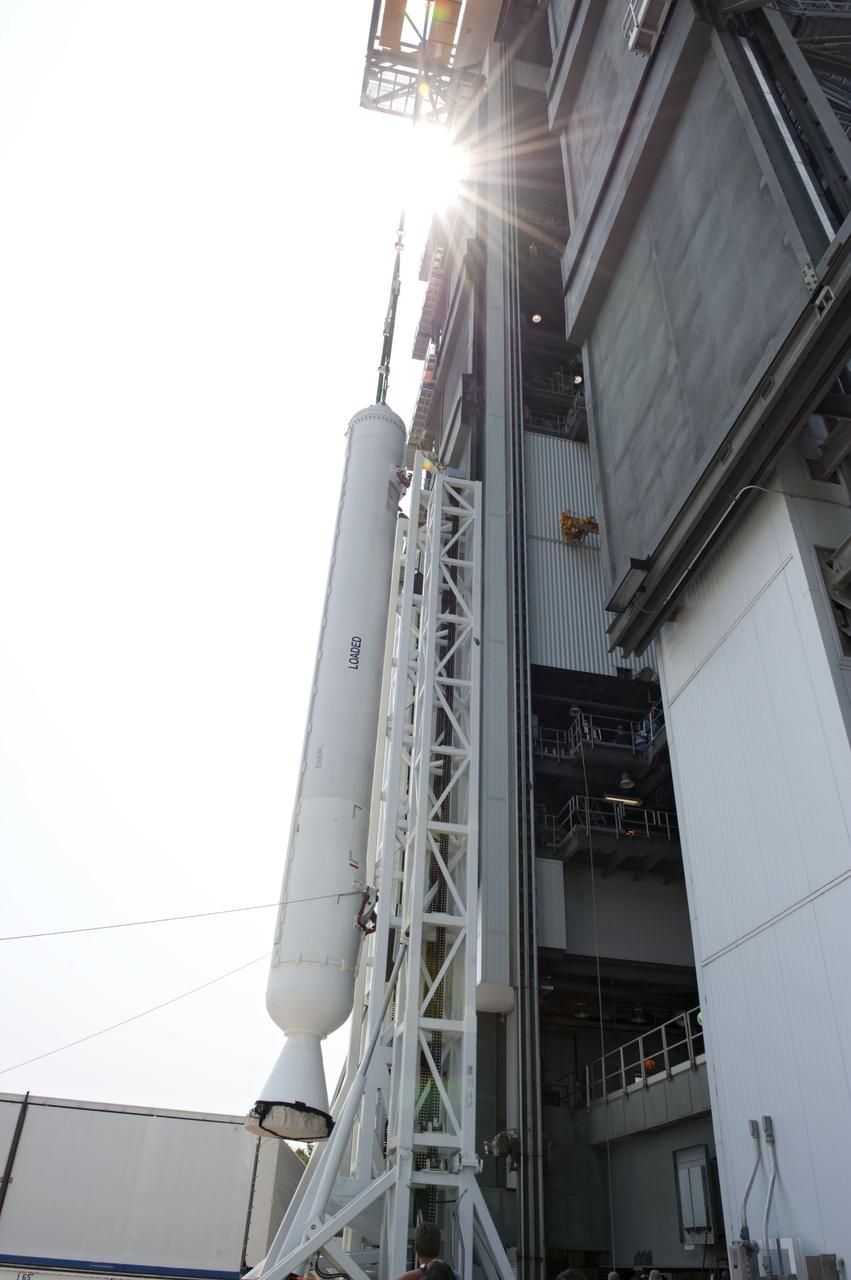 CAPE CANAVERAL, Fla. -- At Cape Canaveral Air Force Station in Florida, workers using an overhead crane lift a solid rocket motor into the Vertical Integration Facility at Launch Complex 41. It then will be attached to the United Launch Alliance Atlas V booster stage, already at the pad. NASA's Juno spacecraft is scheduled to launch aboard an Atlas V from Cape Canaveral, Fla. Aug. 5.The solar-powered spacecraft will orbit Jupiter's poles 33 times to find out more about the gas giant's origins, structure, atmosphere and magnetosphere and investigate the existence of a solid planetary core. For more information visit: www.nasa.gov/juno. Photo credit: NASA/Kim Shiflett