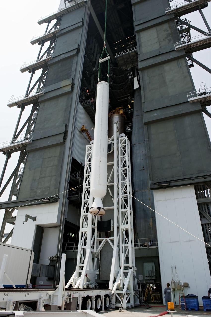 CAPE CANAVERAL, Fla. -- At Cape Canaveral Air Force Station in Florida, workers using an overhead crane lift a solid rocket motor into the Vertical Integration Facility at Launch Complex 41. It then will be attached to the United Launch Alliance Atlas V booster stage, already at the pad. NASA's Juno spacecraft is scheduled to launch aboard an Atlas V from Cape Canaveral, Fla. Aug. 5.The solar-powered spacecraft will orbit Jupiter's poles 33 times to find out more about the gas giant's origins, structure, atmosphere and magnetosphere and investigate the existence of a solid planetary core. For more information visit: www.nasa.gov/juno. Photo credit: NASA/Kim Shiflett