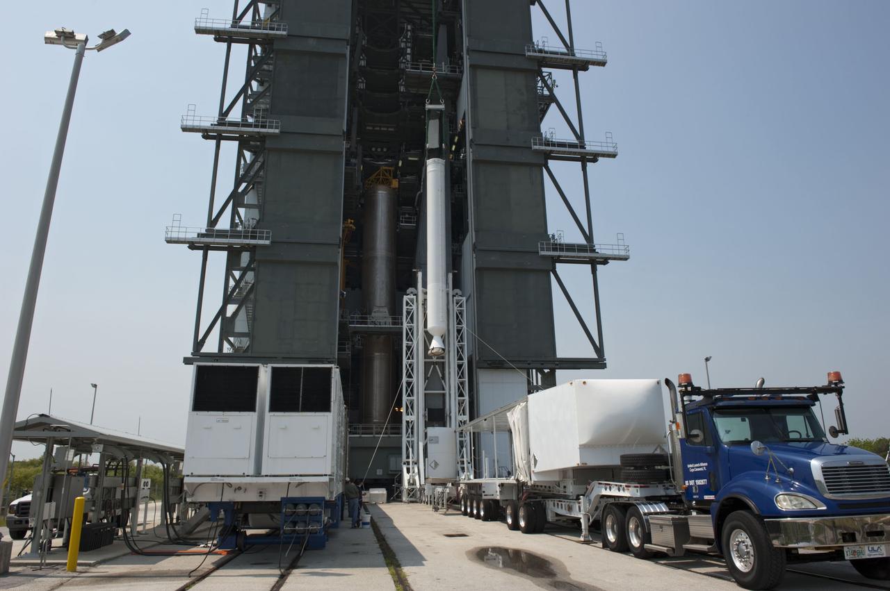 CAPE CANAVERAL, Fla. -- At Cape Canaveral Air Force Station in Florida, workers using an overhead crane lift a solid rocket motor into the Vertical Integration Facility at Launch Complex 41. It then will be attached to the United Launch Alliance Atlas V booster stage, already at the pad. NASA's Juno spacecraft is scheduled to launch aboard an Atlas V from Cape Canaveral, Fla. Aug. 5.The solar-powered spacecraft will orbit Jupiter's poles 33 times to find out more about the gas giant's origins, structure, atmosphere and magnetosphere and investigate the existence of a solid planetary core. For more information visit: www.nasa.gov/juno. Photo credit: NASA/Kim Shiflett