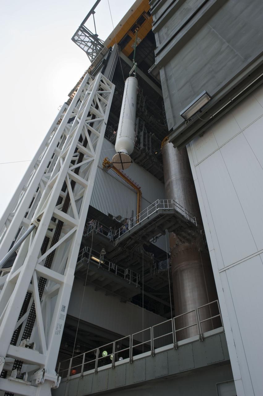 CAPE CANAVERAL, Fla. -- At Cape Canaveral Air Force Station in Florida, workers using an overhead crane lift a solid rocket motor into the Vertical Integration Facility at Launch Complex 41. It then will be attached to the United Launch Alliance Atlas V booster stage, already at the pad. NASA's Juno spacecraft is scheduled to launch aboard an Atlas V from Cape Canaveral, Fla. Aug. 5.The solar-powered spacecraft will orbit Jupiter's poles 33 times to find out more about the gas giant's origins, structure, atmosphere and magnetosphere and investigate the existence of a solid planetary core. For more information visit: www.nasa.gov/juno. Photo credit: NASA/Kim Shiflett